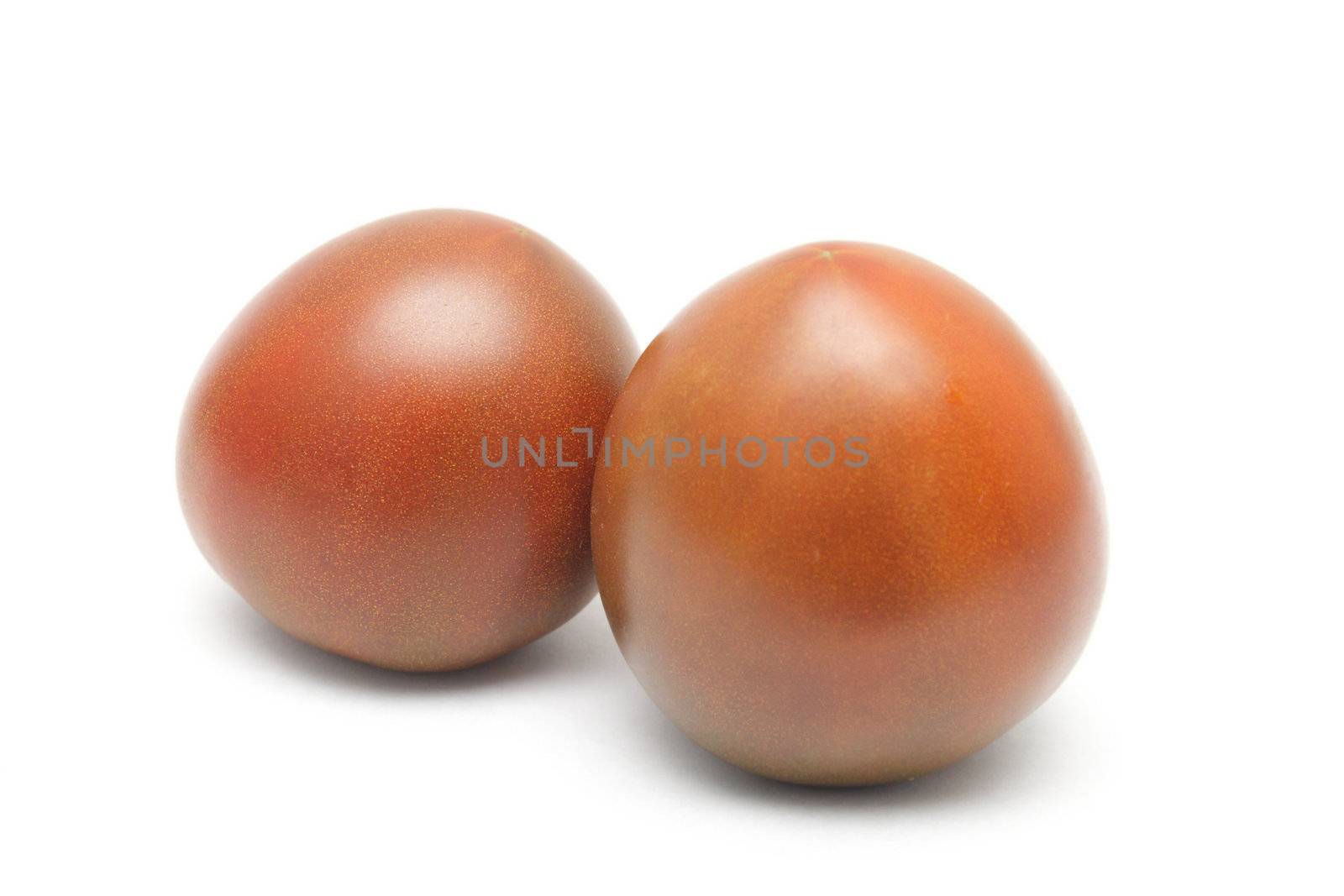 Two Black Prince tomatoes isolated on white background