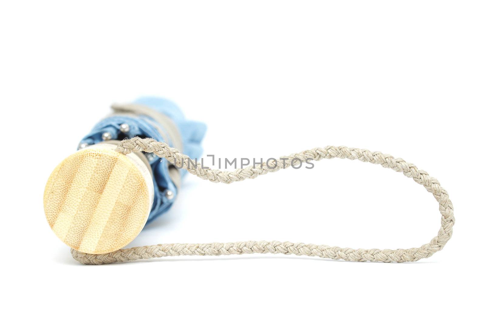 Folded greyish blue umbrella isolated on white background