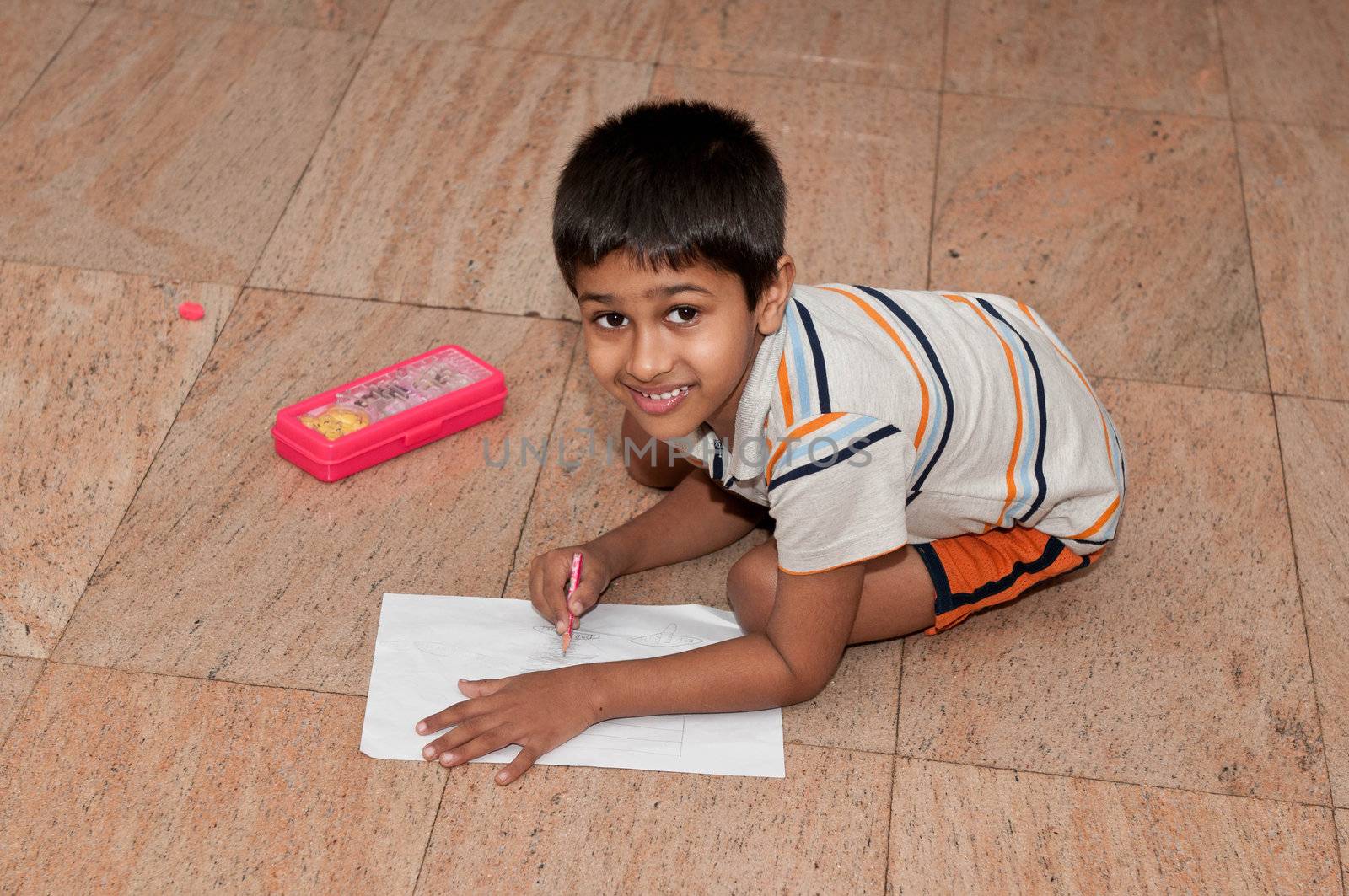 an handsome indian kid doing homework