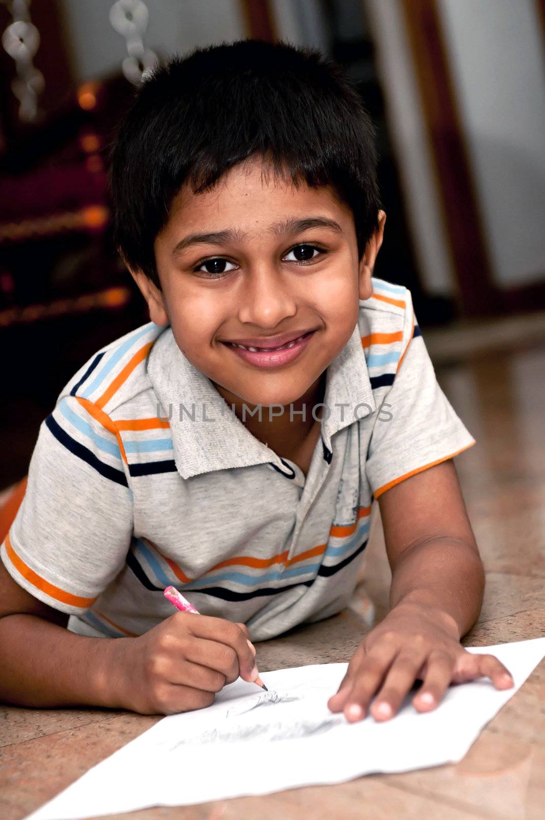 an handsome indian kid doing homework