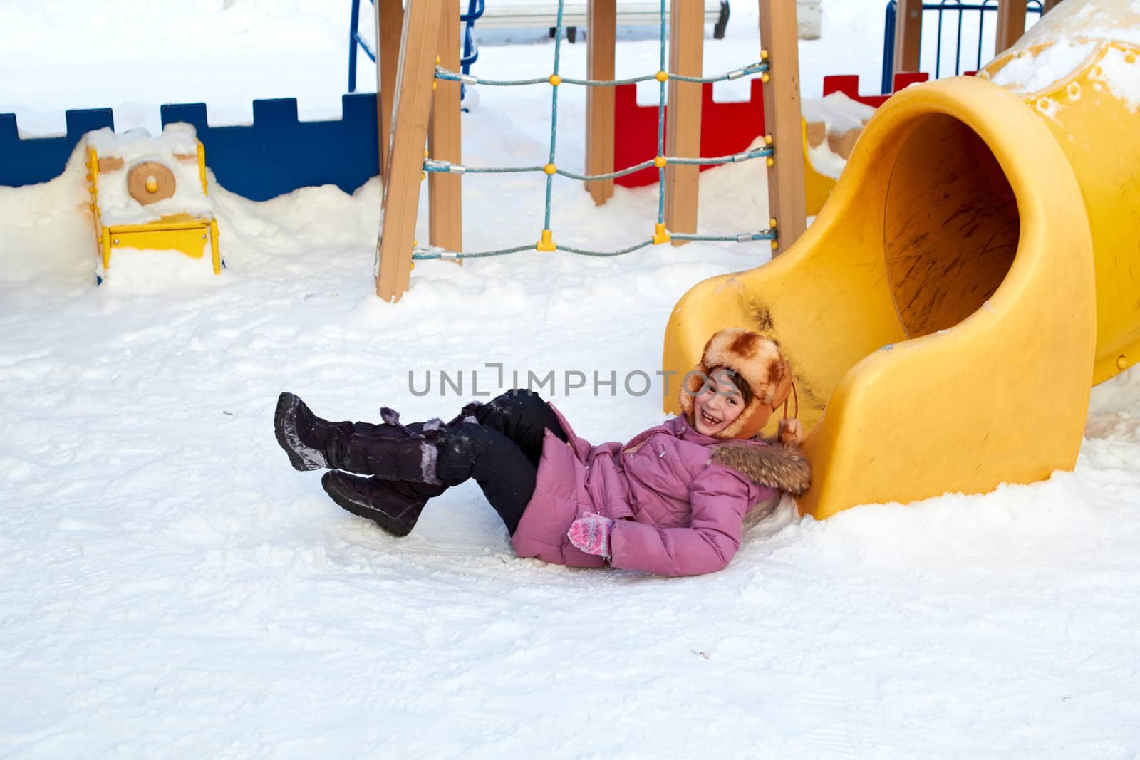 The girl just came from tube at a childrens play area in winter