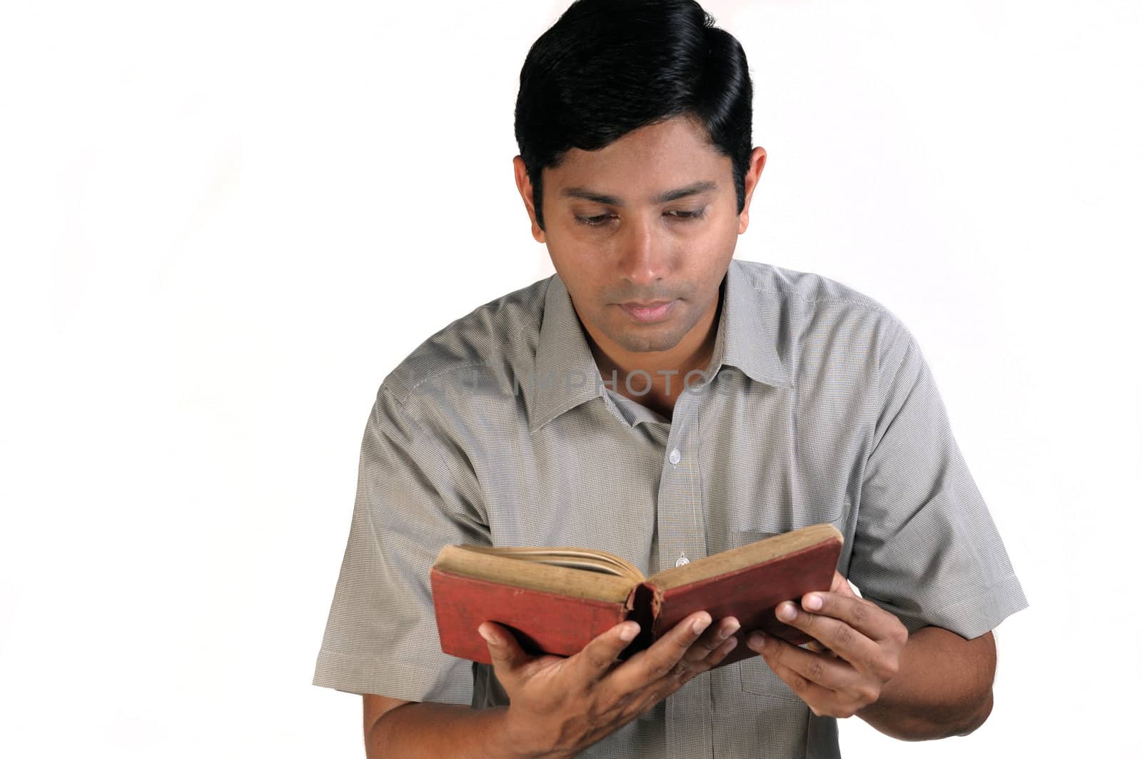 An handsome middle aged man reading an old book