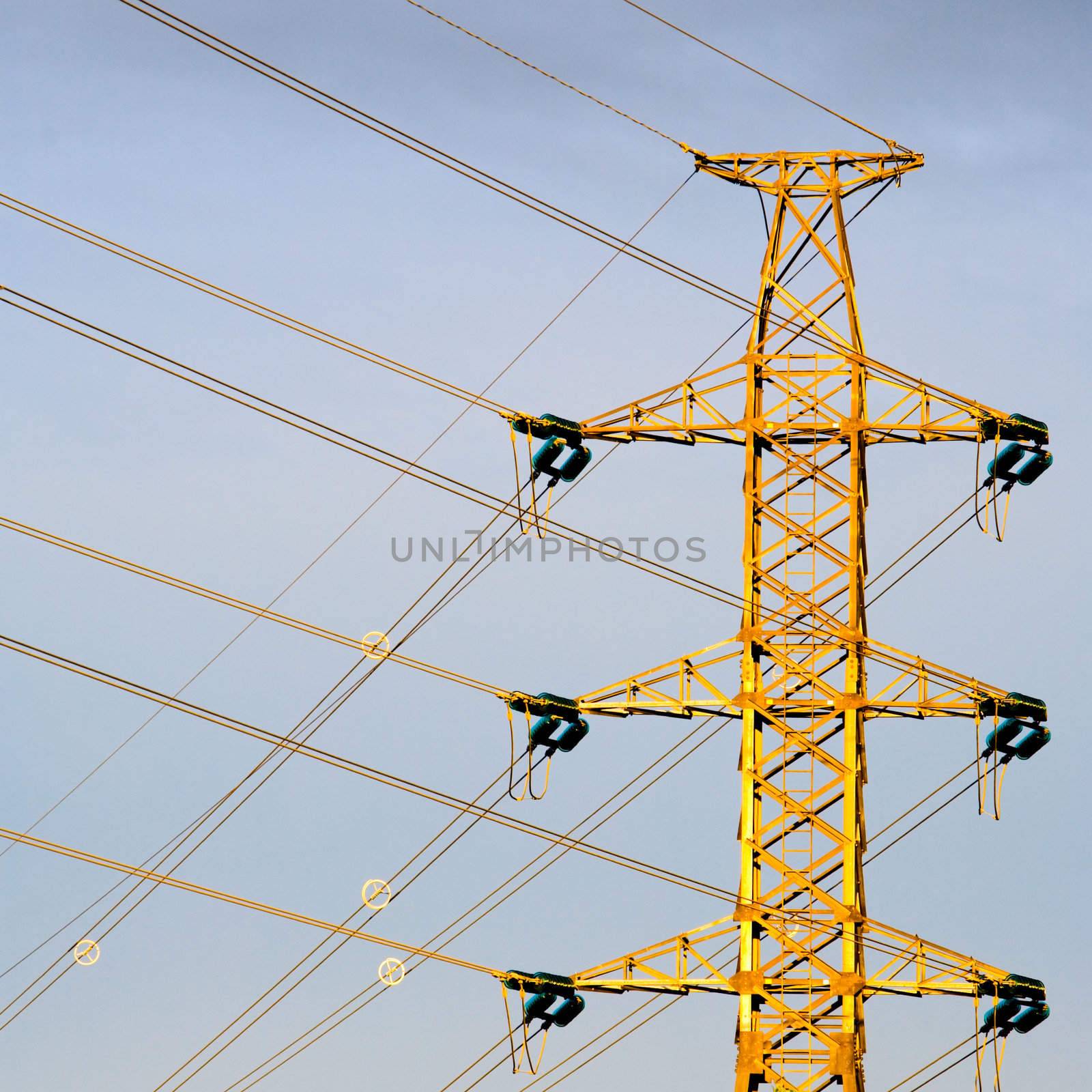 Electricity pylon against a hazy blue sky