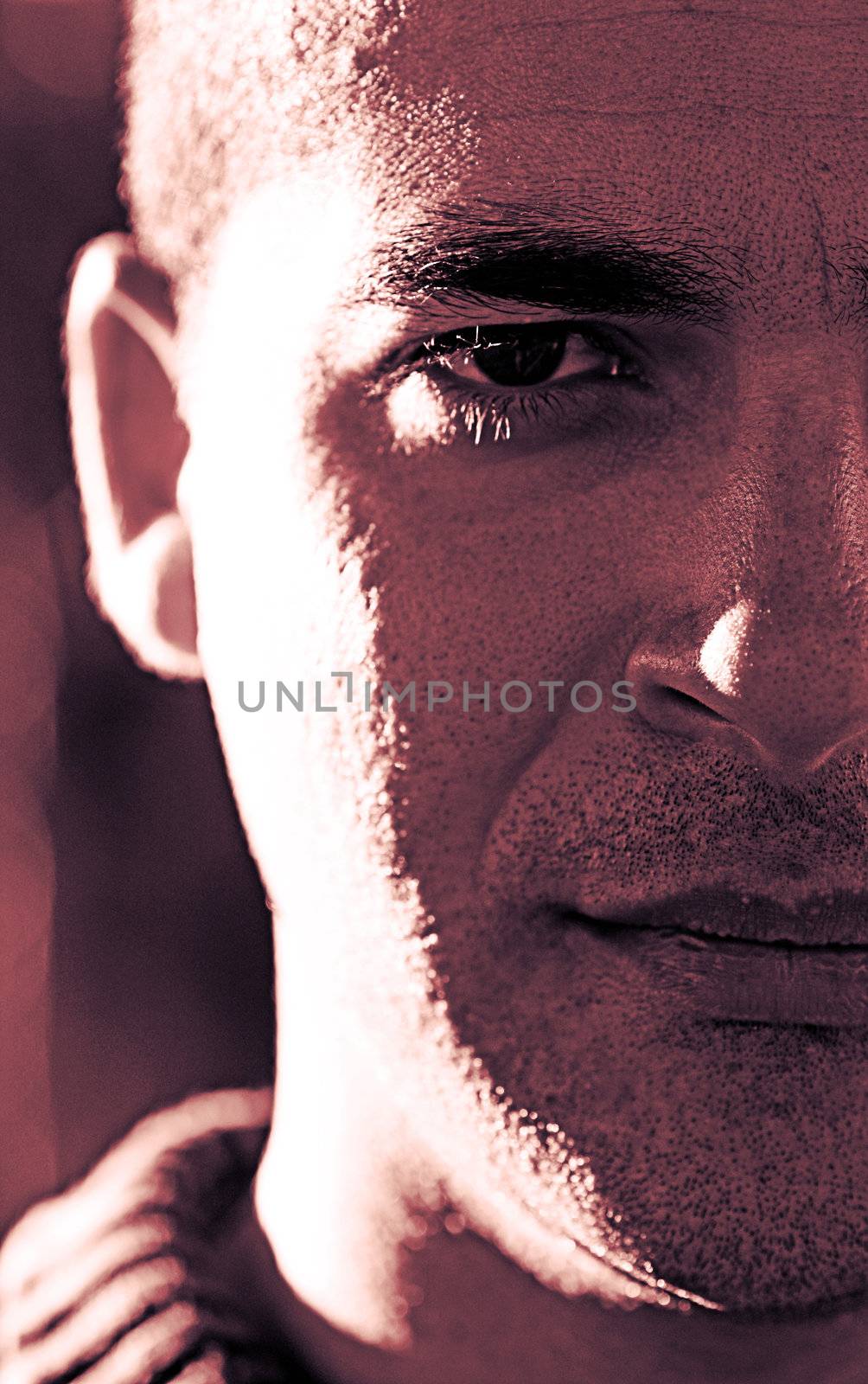 Closeup shot of one side of the face of a young man, with confident expression.