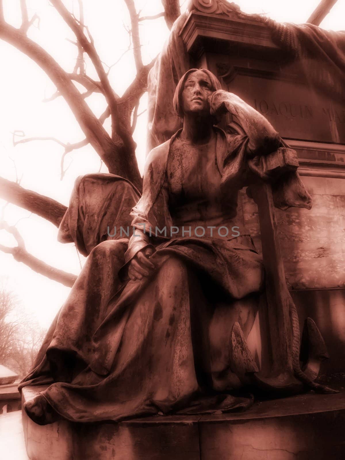 Meditating woman statue in parisian Pere Lachaise cemetery
