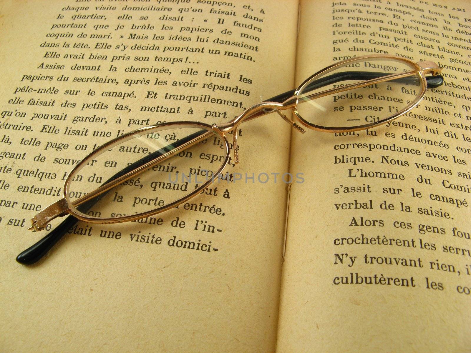 glasses on a book by jbouzou