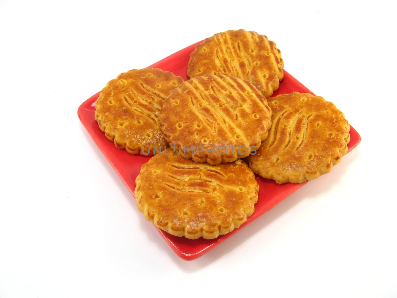 image of a plate with some biscuits over a white background