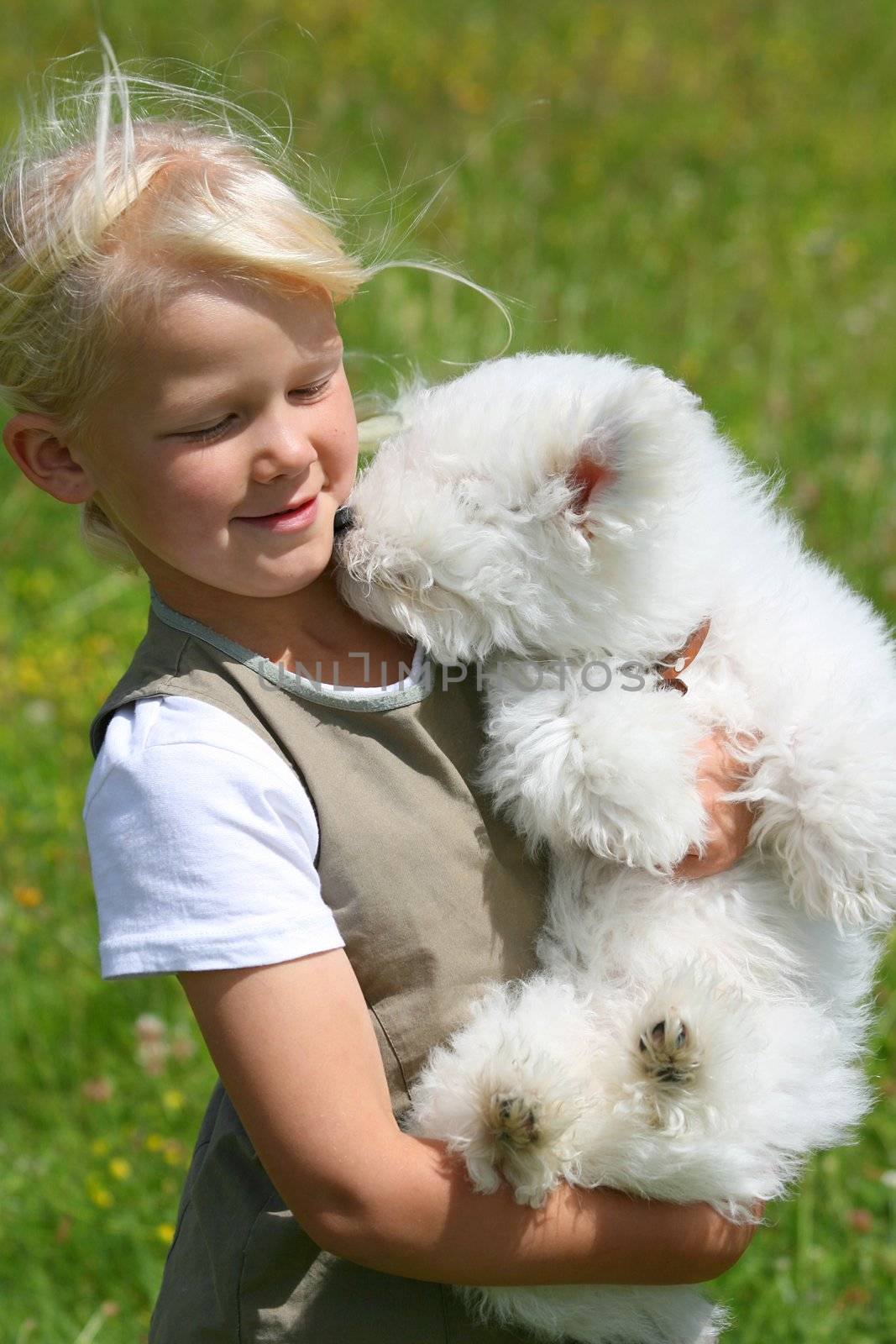 Happy girl bearing a puppy in her arms