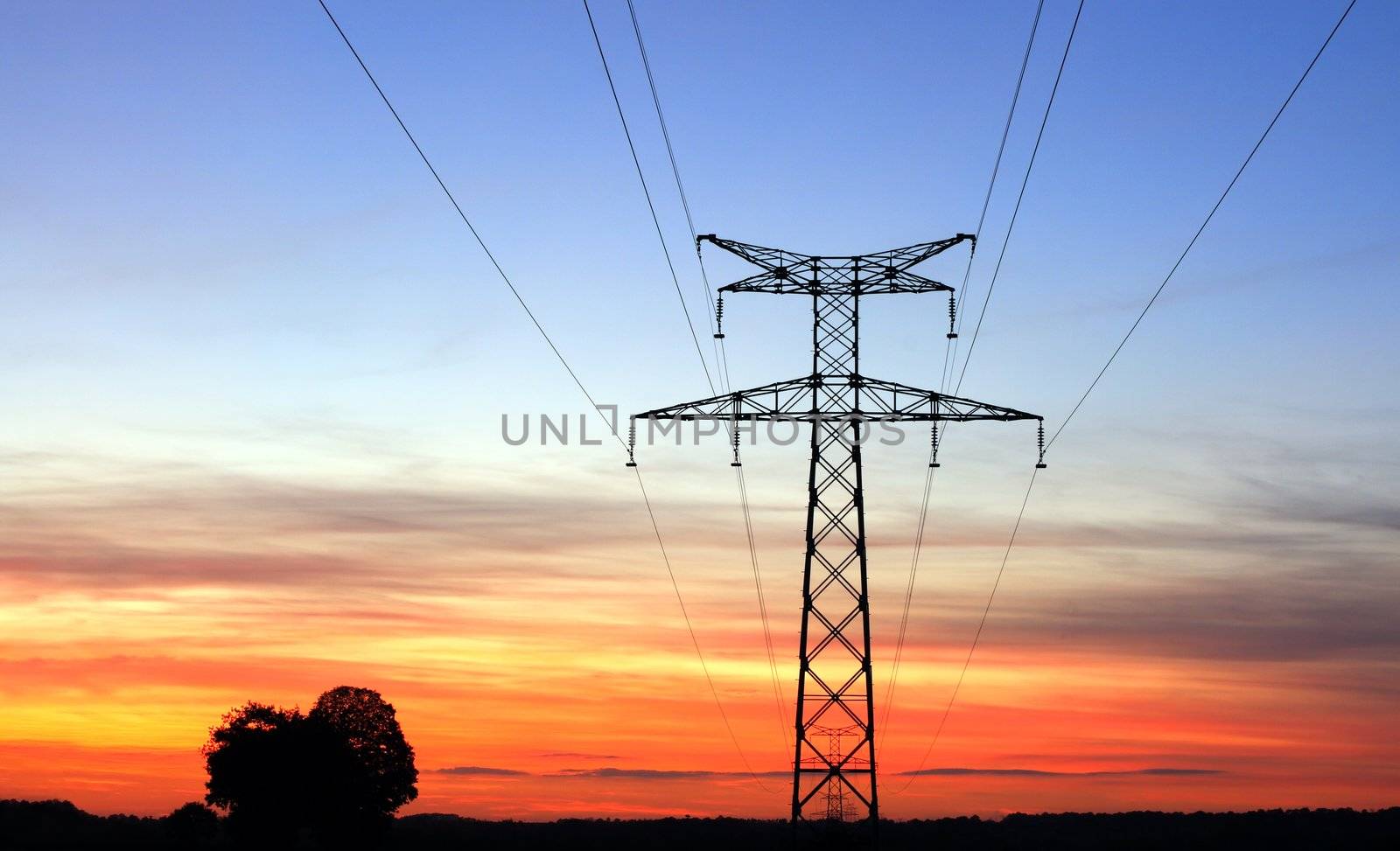 Electricity pylons, over a sunset sky