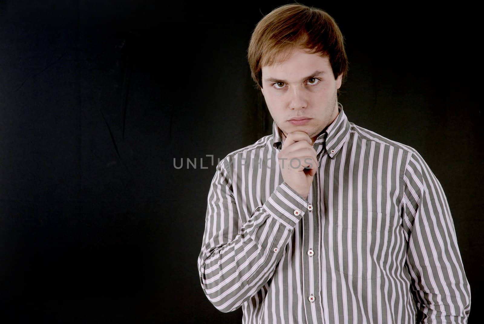 young business man portrait in a dark background