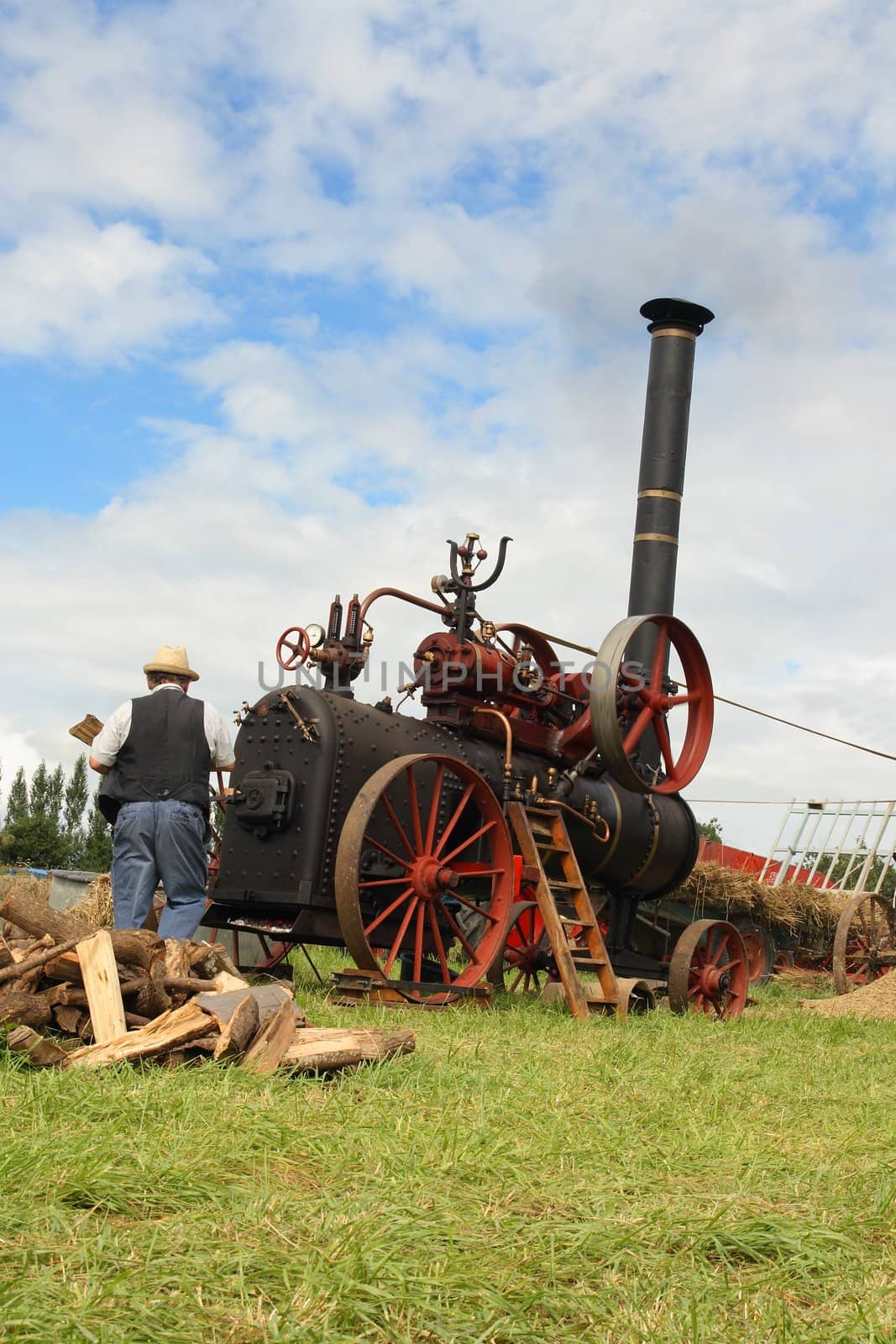 Vintage traction steam engine working in a field at the wheat fest