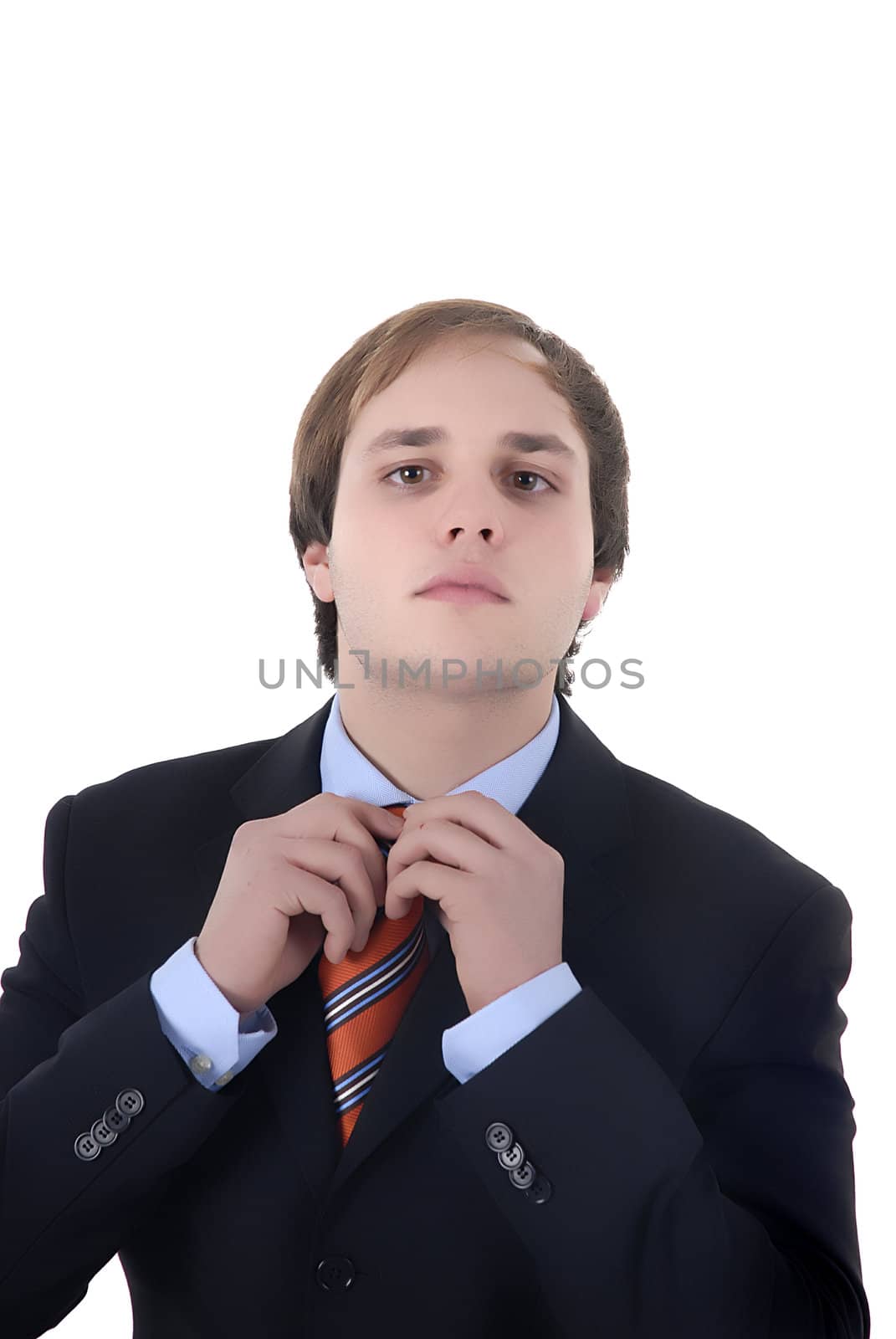 Businessman fixing his tie isolated in white background