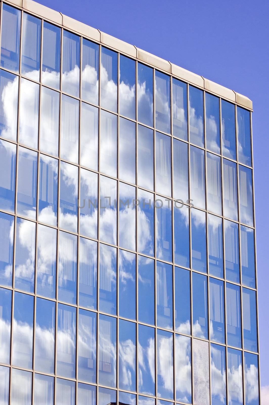 Blue sky and clouds reflected in the glass building