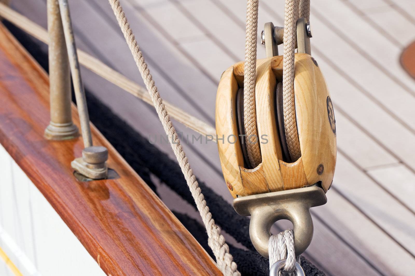 Detail of a wooden sailboat: pulley with ropes