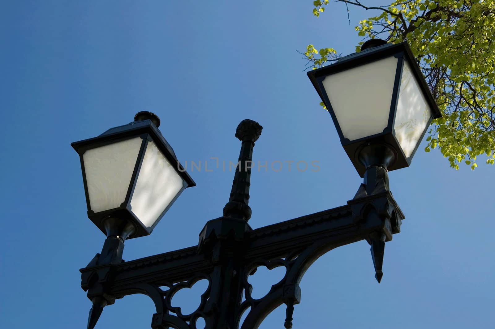 Two street lanterns on a background of the blue sky