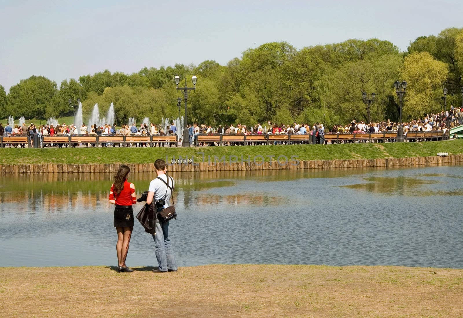 Married couple on a beach of park pond