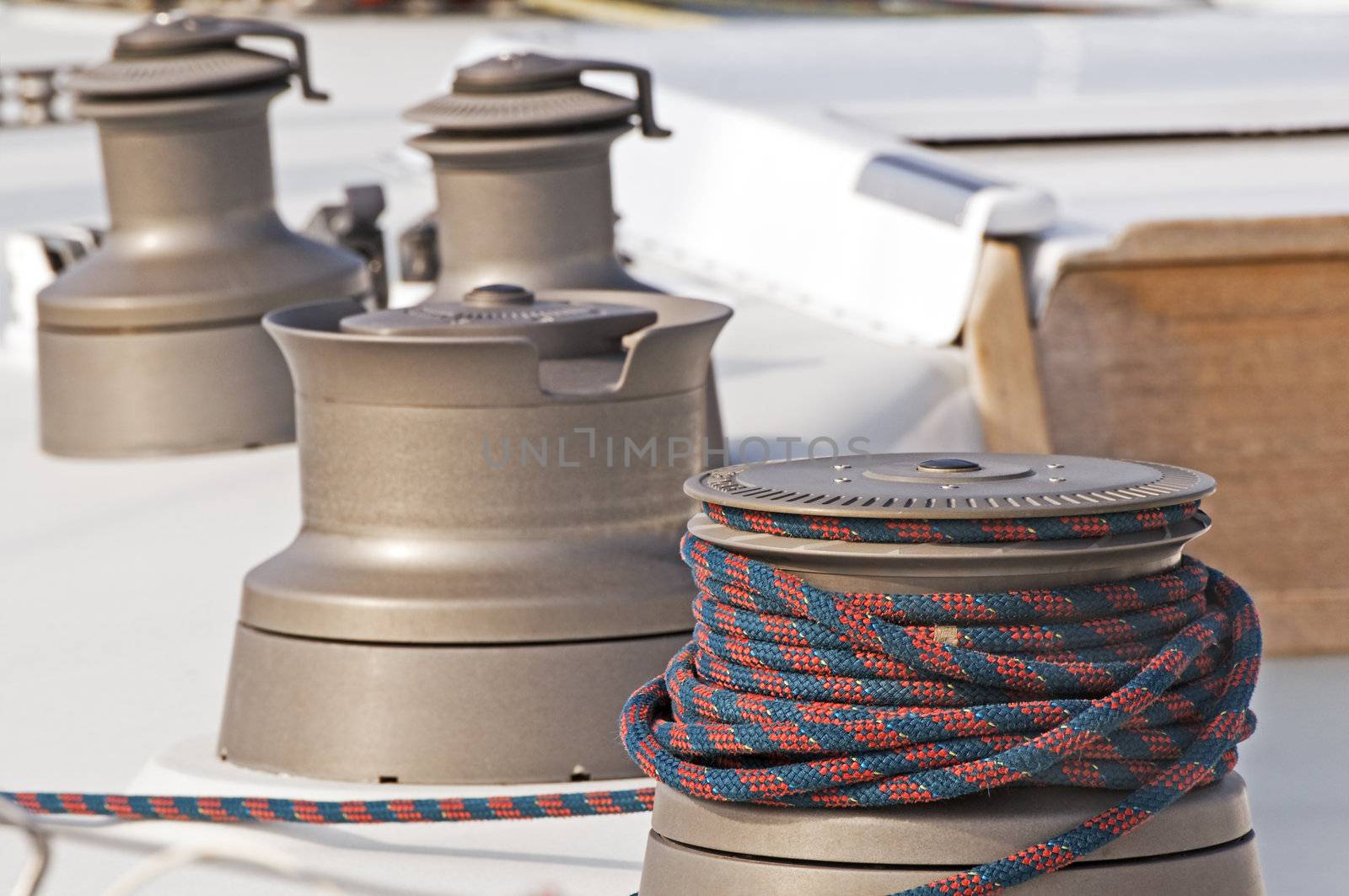 Four winches used to control sails on a boat