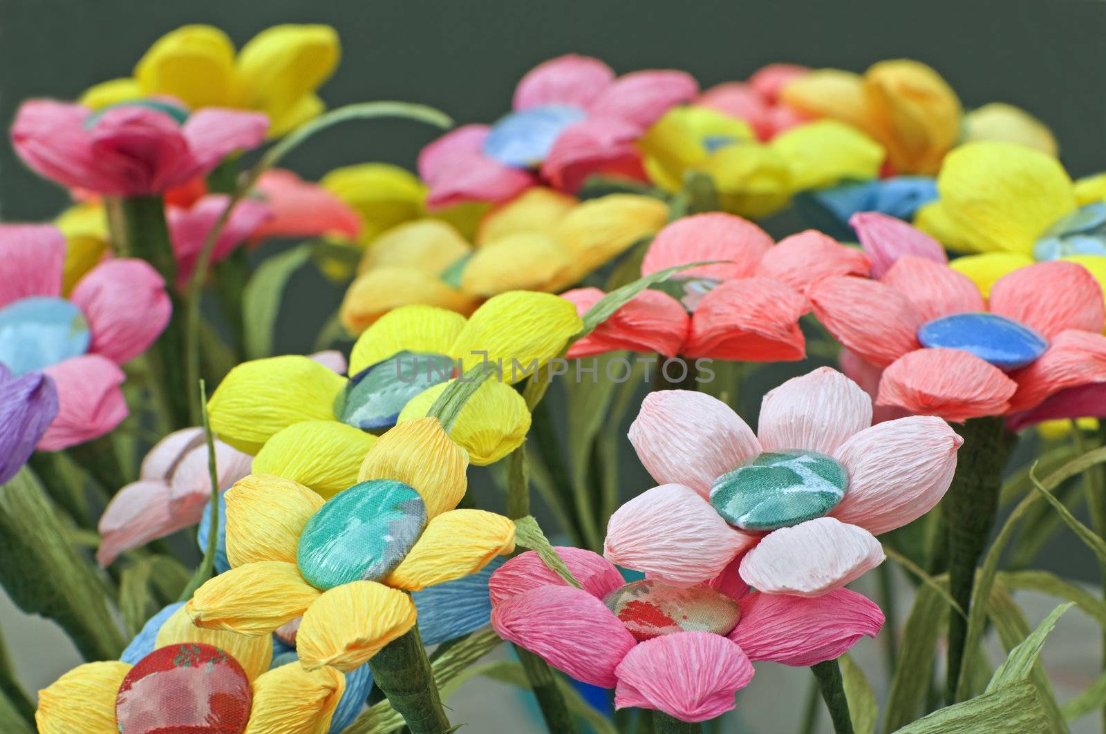 Many coloured handmade flowers made with crepe paper