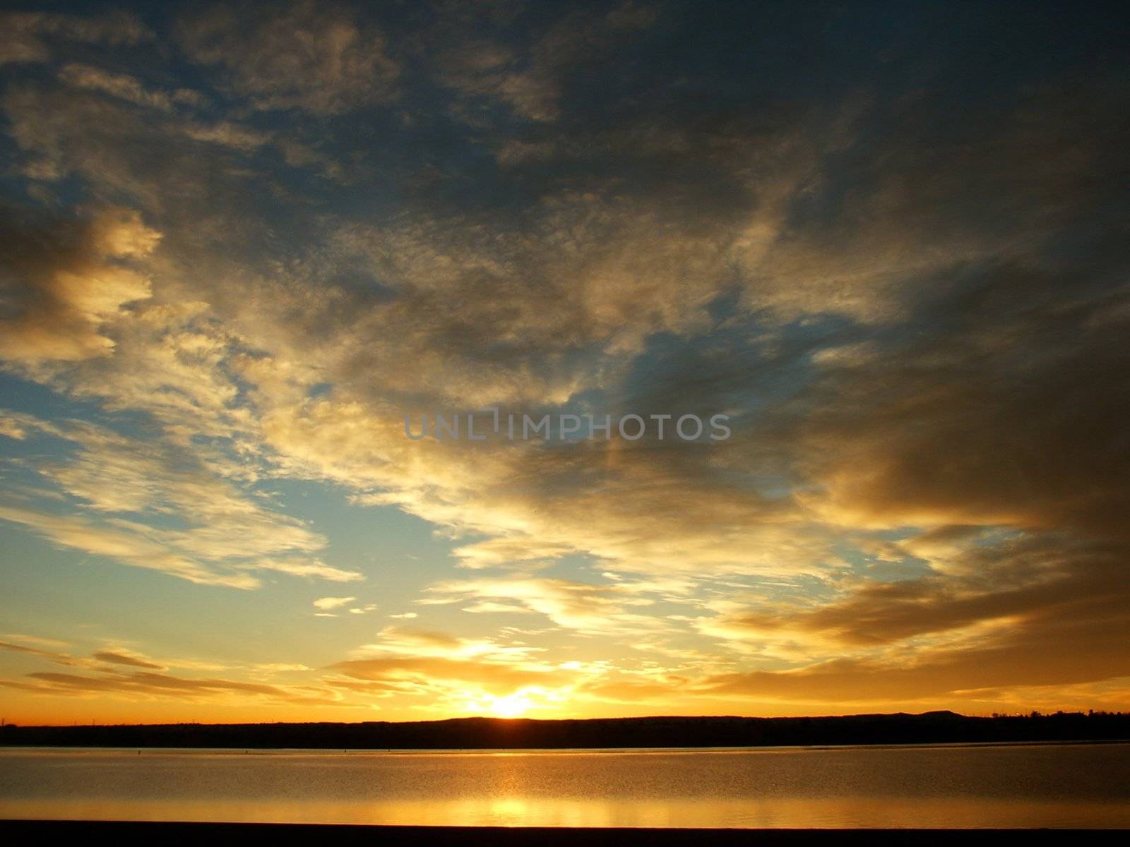 Gold and Orange sunrise with a lake by jdebordphoto