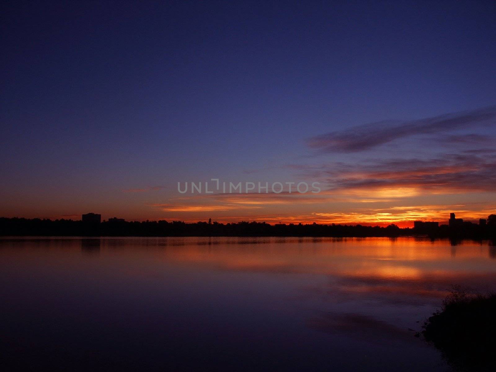 Sunrise ina  city Park with a Lake by jdebordphoto
