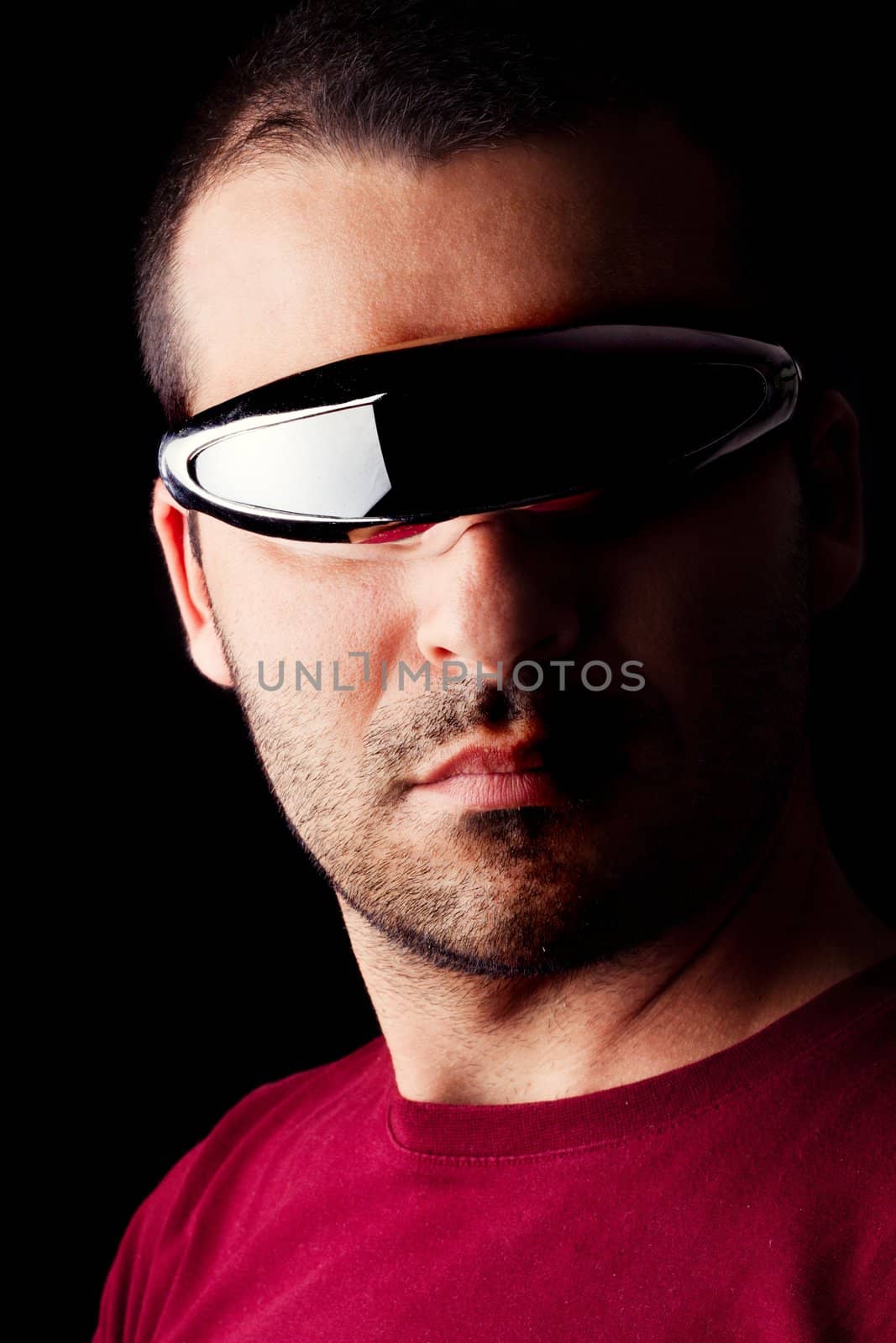 Close detail view of a young male man with futurist glasses isolated on a black background.