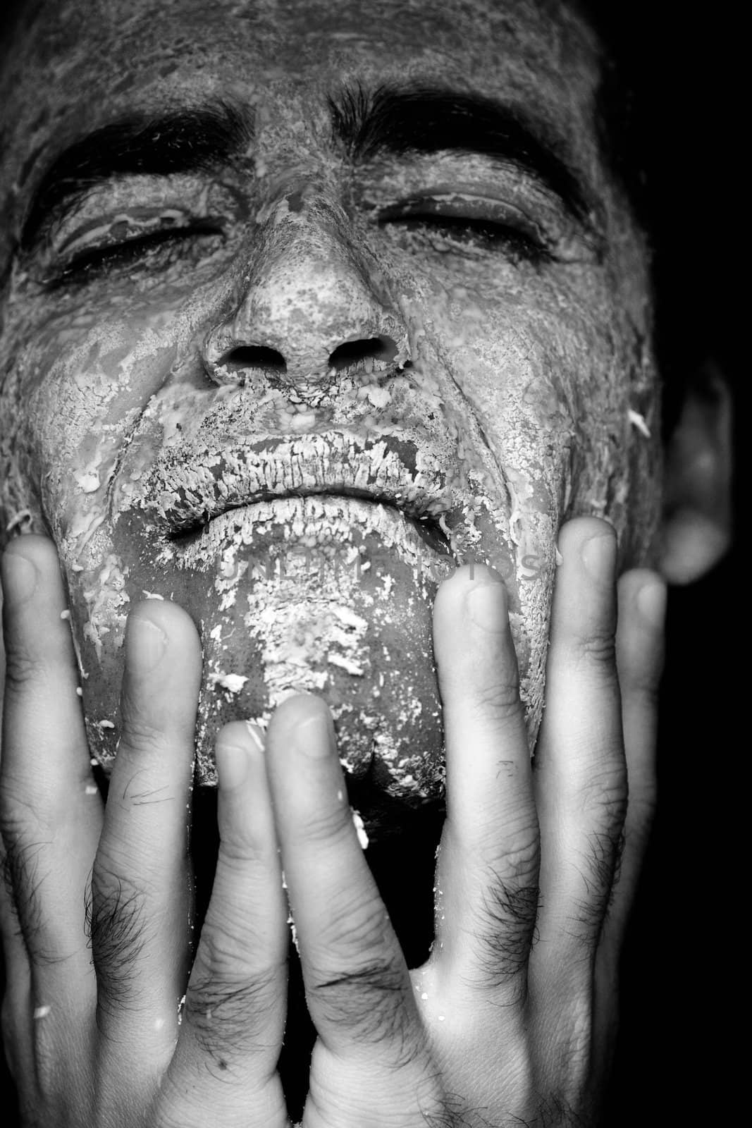 Close up view of a man's hands removing the mask from the face.