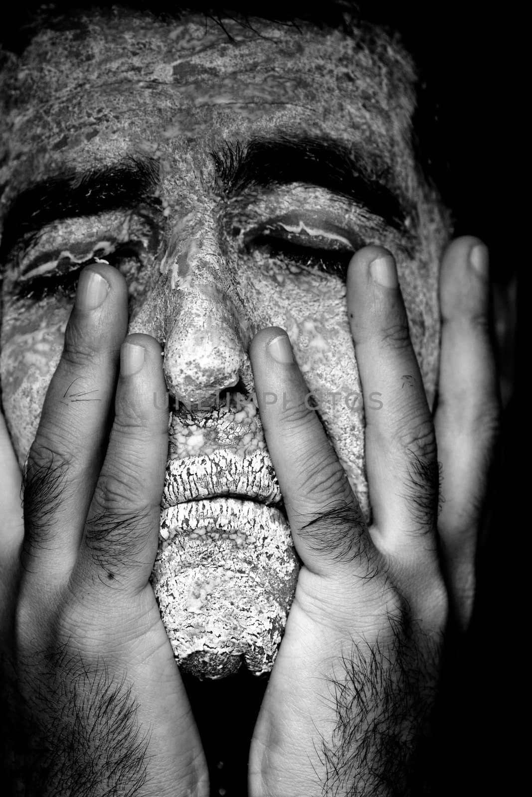 Close up view of a man's hands removing the mask from the face.