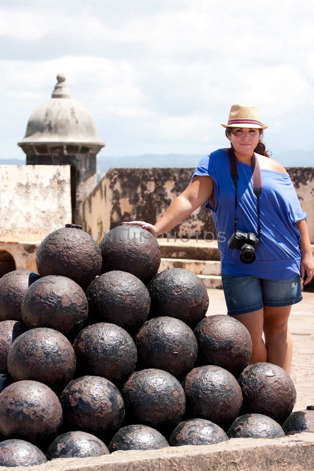 View of the upper interior of El Morro fort located in Old San Juan Puerto Rico.  There is a large pile of canon balls in a pyramid shape.
