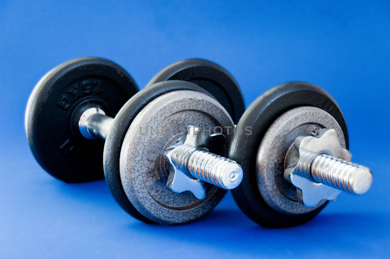 A pair of barbells on a blue background