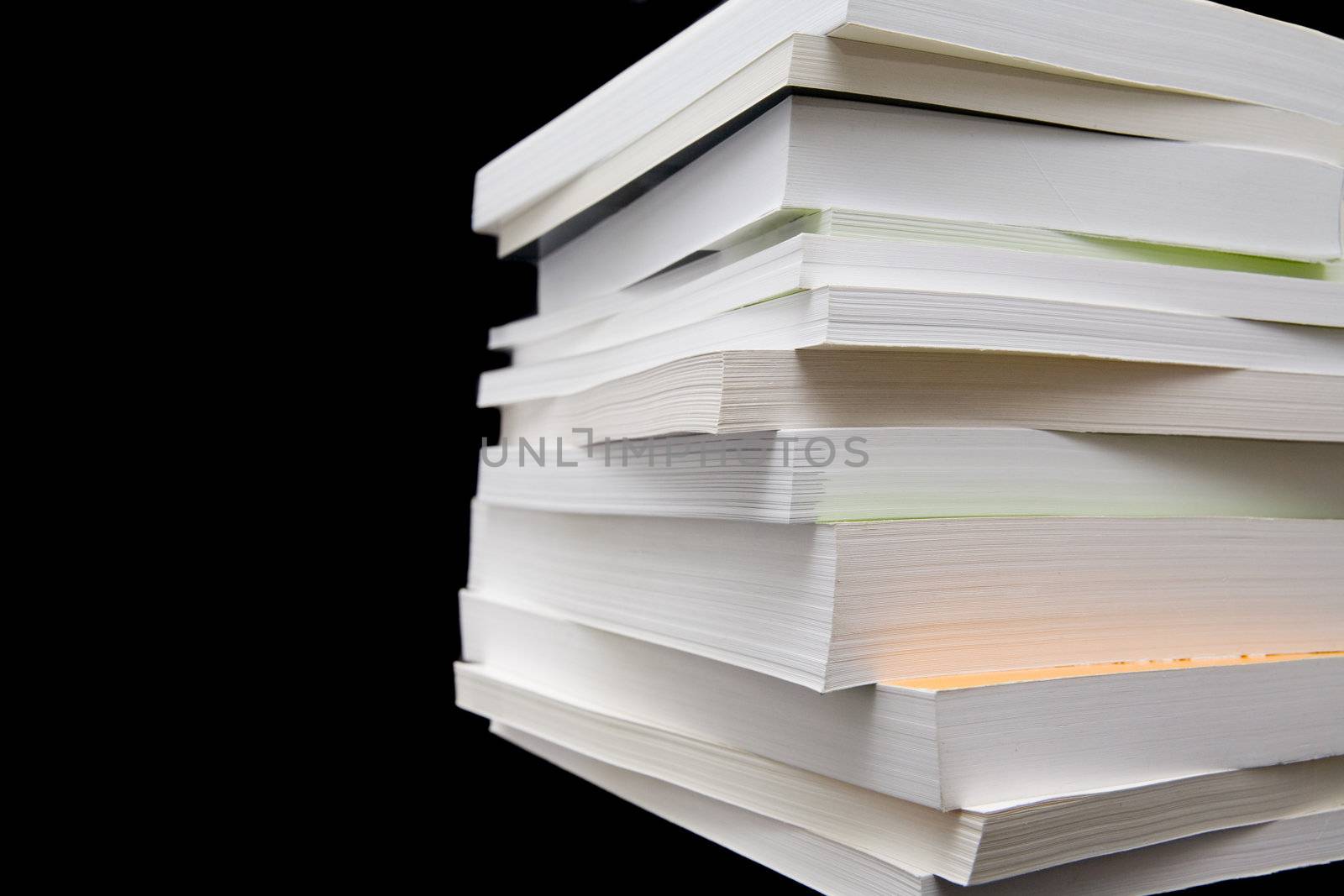 Paperback books (manuals) on a black background