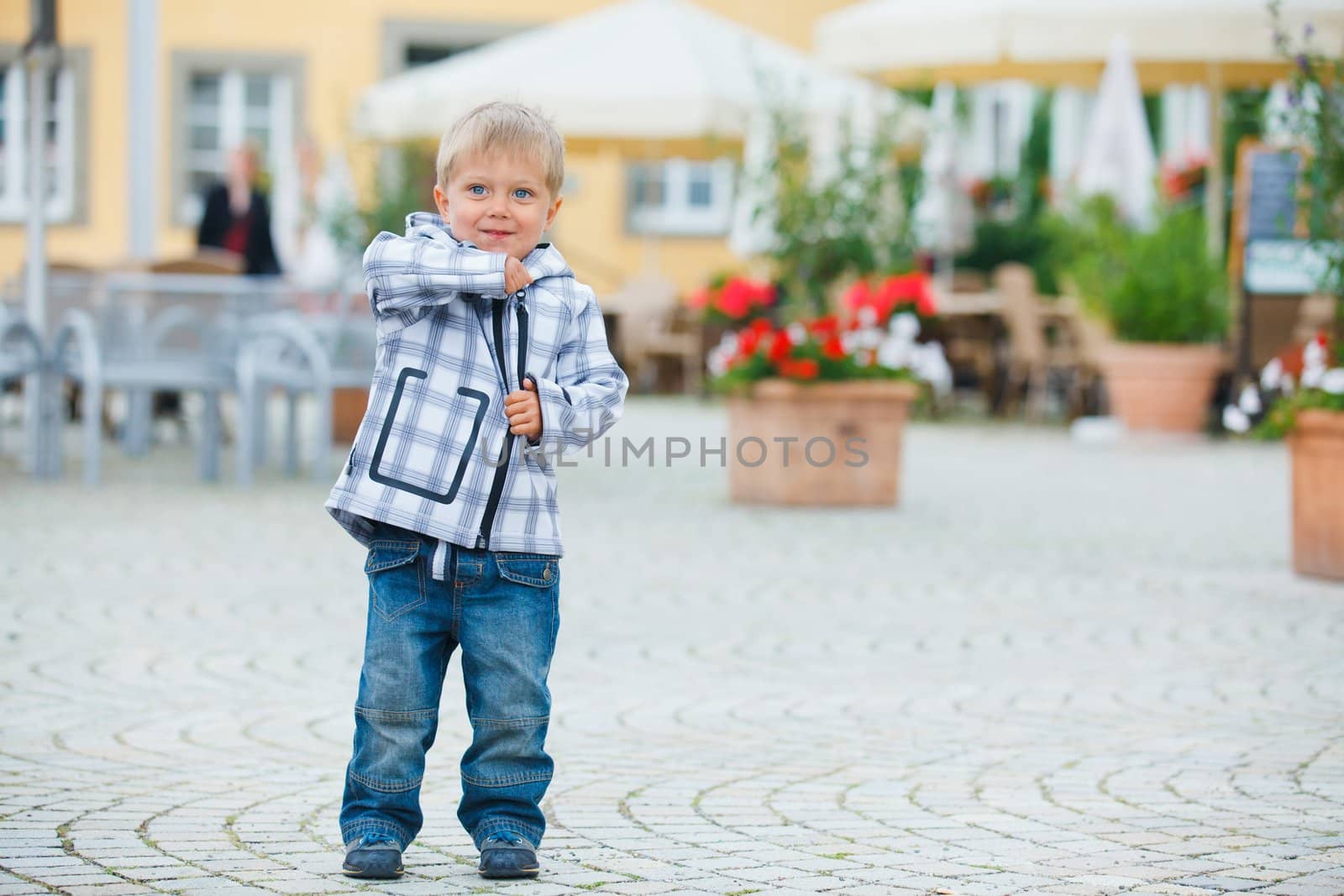 cute little boy outdoors in city street
