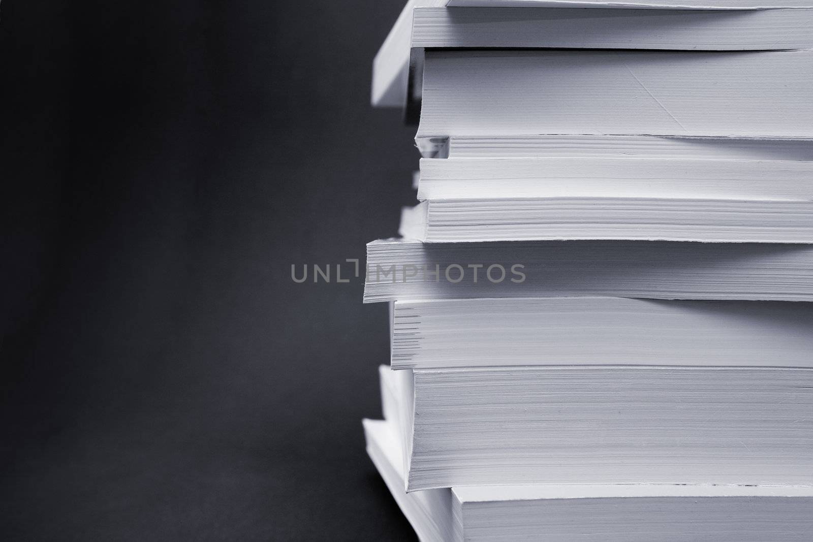 Paperback books (manuals) on a black background