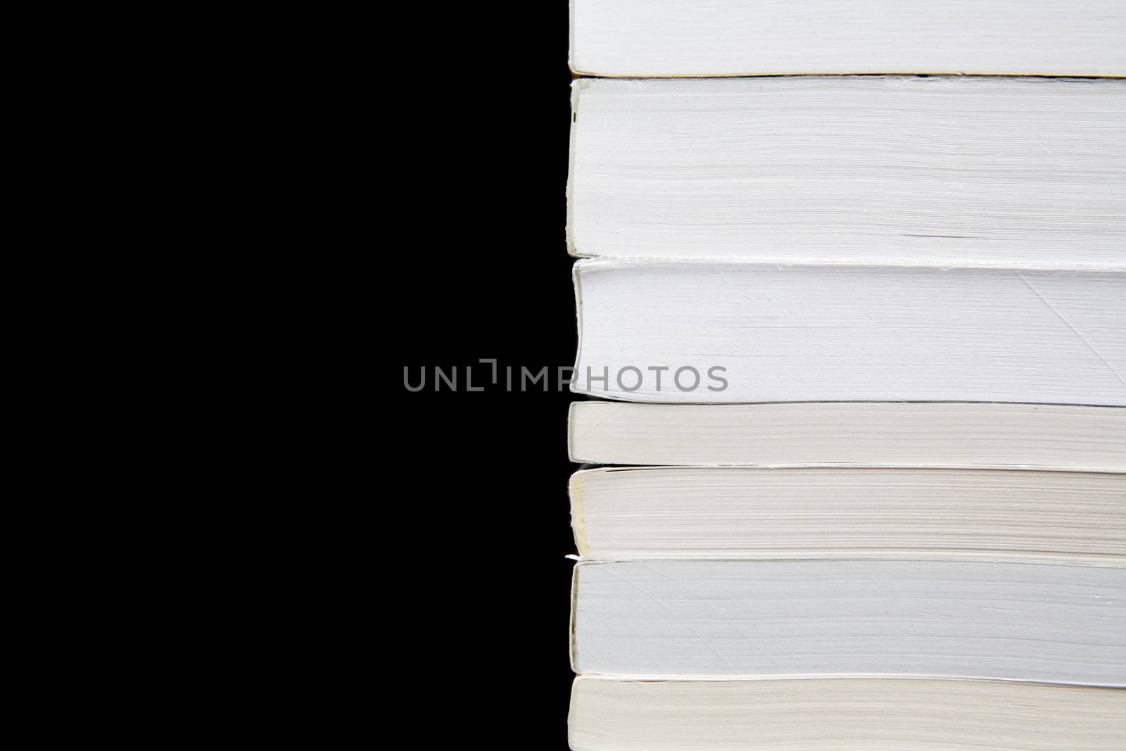 Paperback books (manuals) on a black background