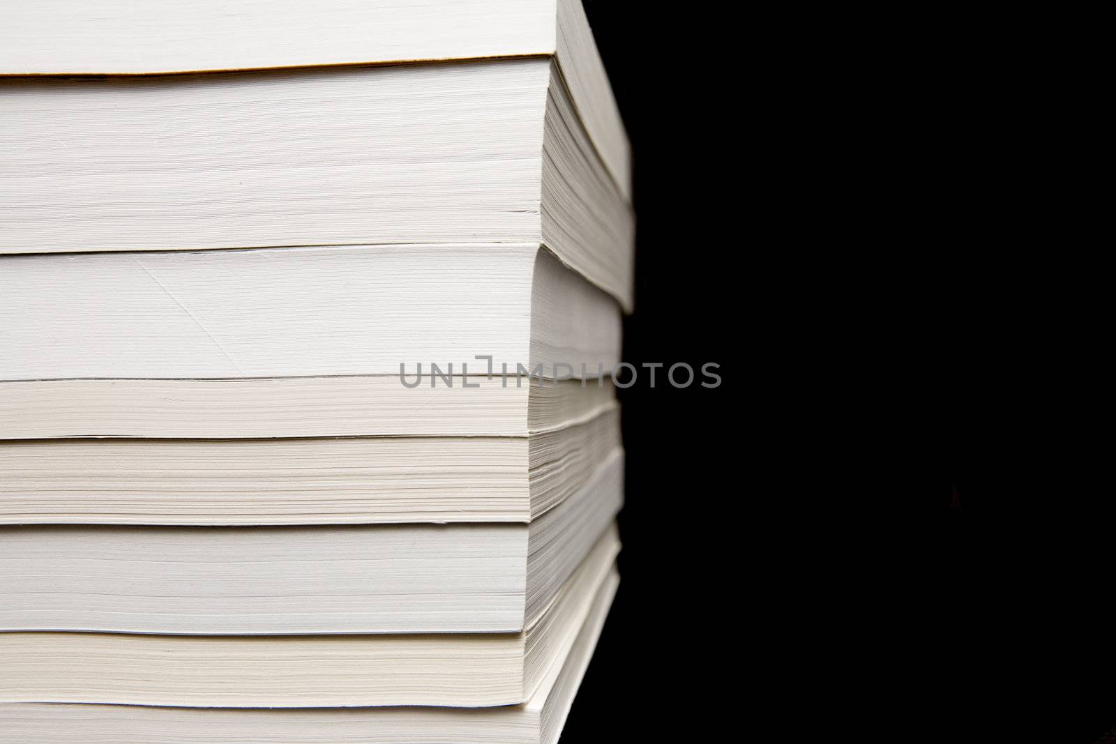 Paperback books (manuals) on a black background