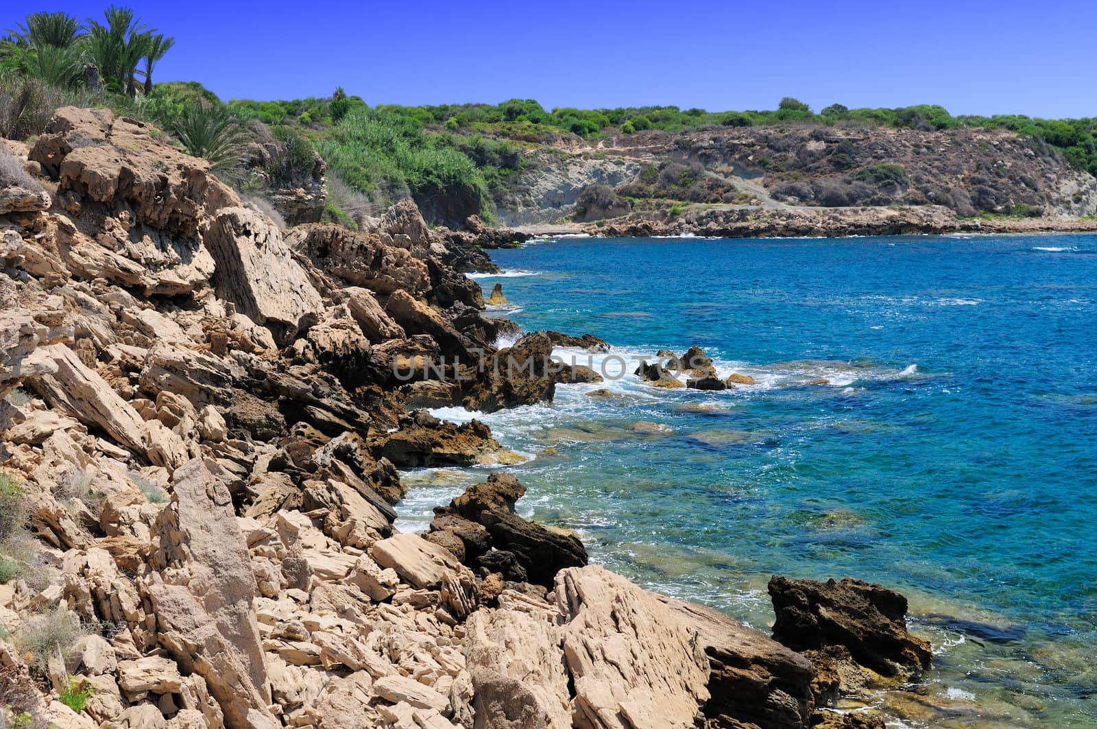 Rocky shore of the Mediterranean sea with clear water.