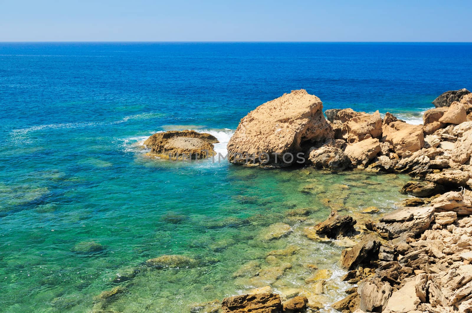 Rocky shore of the Mediterranean sea with clear water.