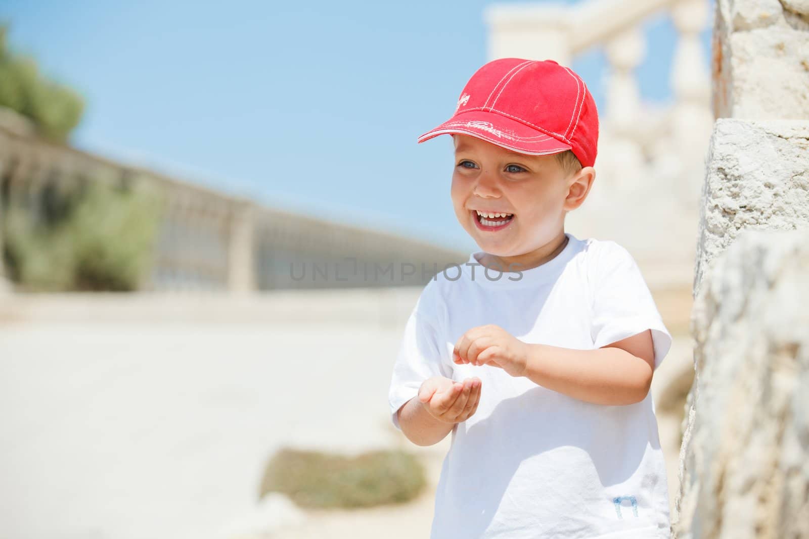 A close-up portrait of cute boy in a red cap