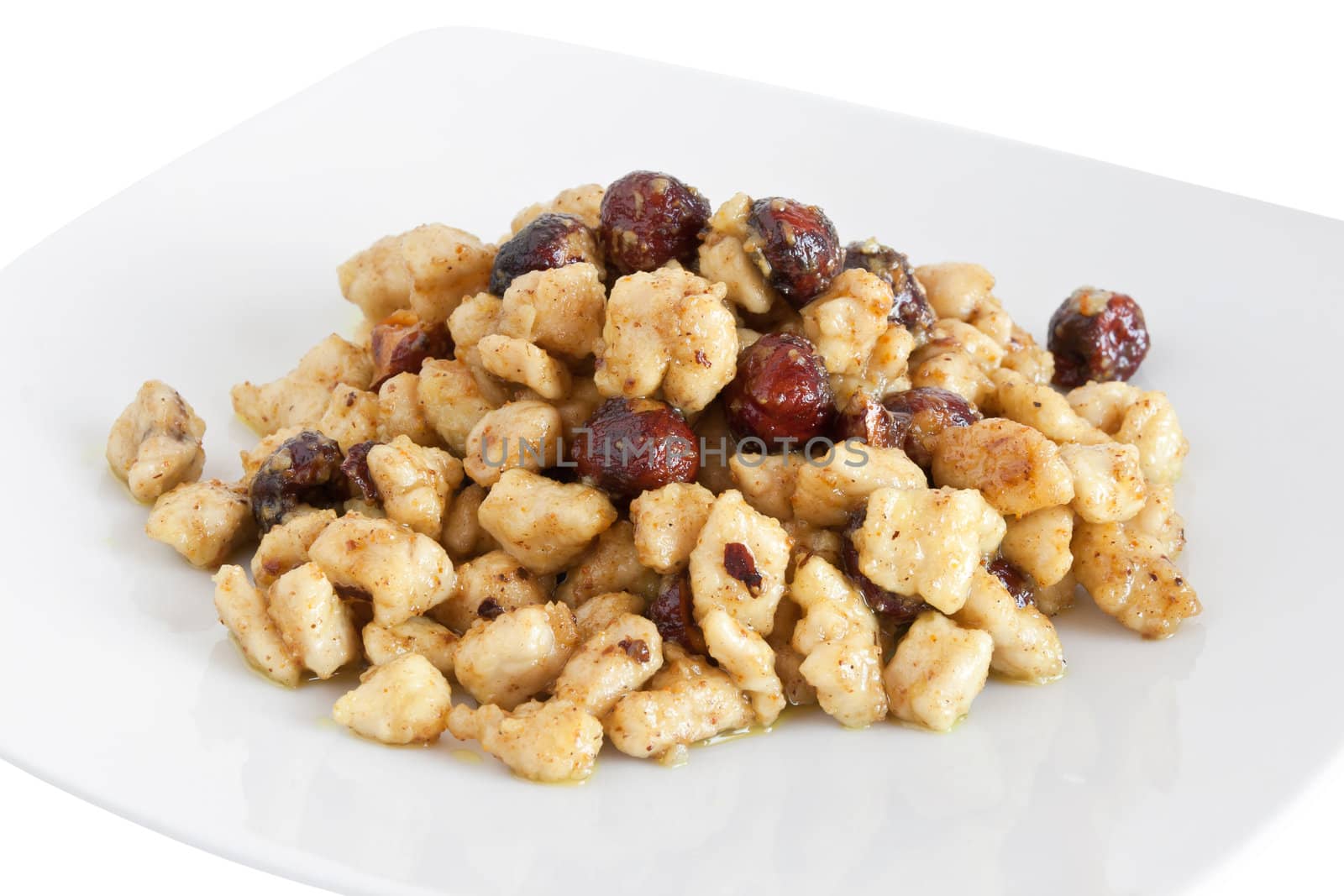 plate with chicken and nuts isolated on white background with clipping path