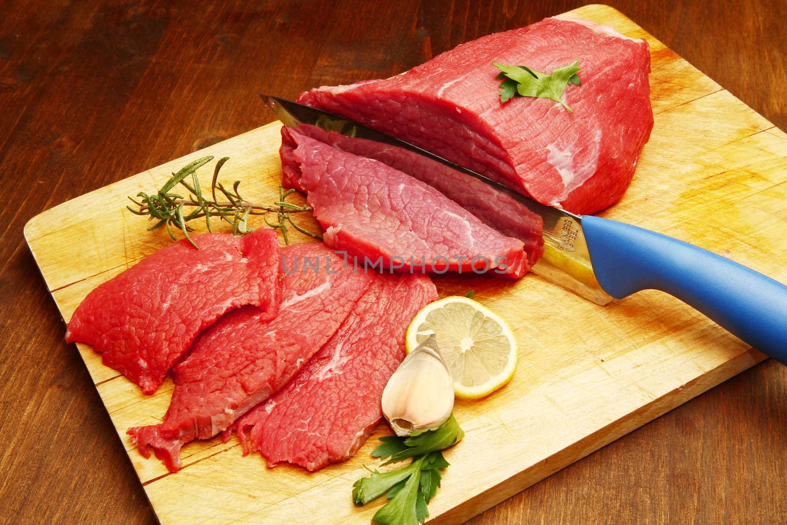 Raw beef on wooden board
