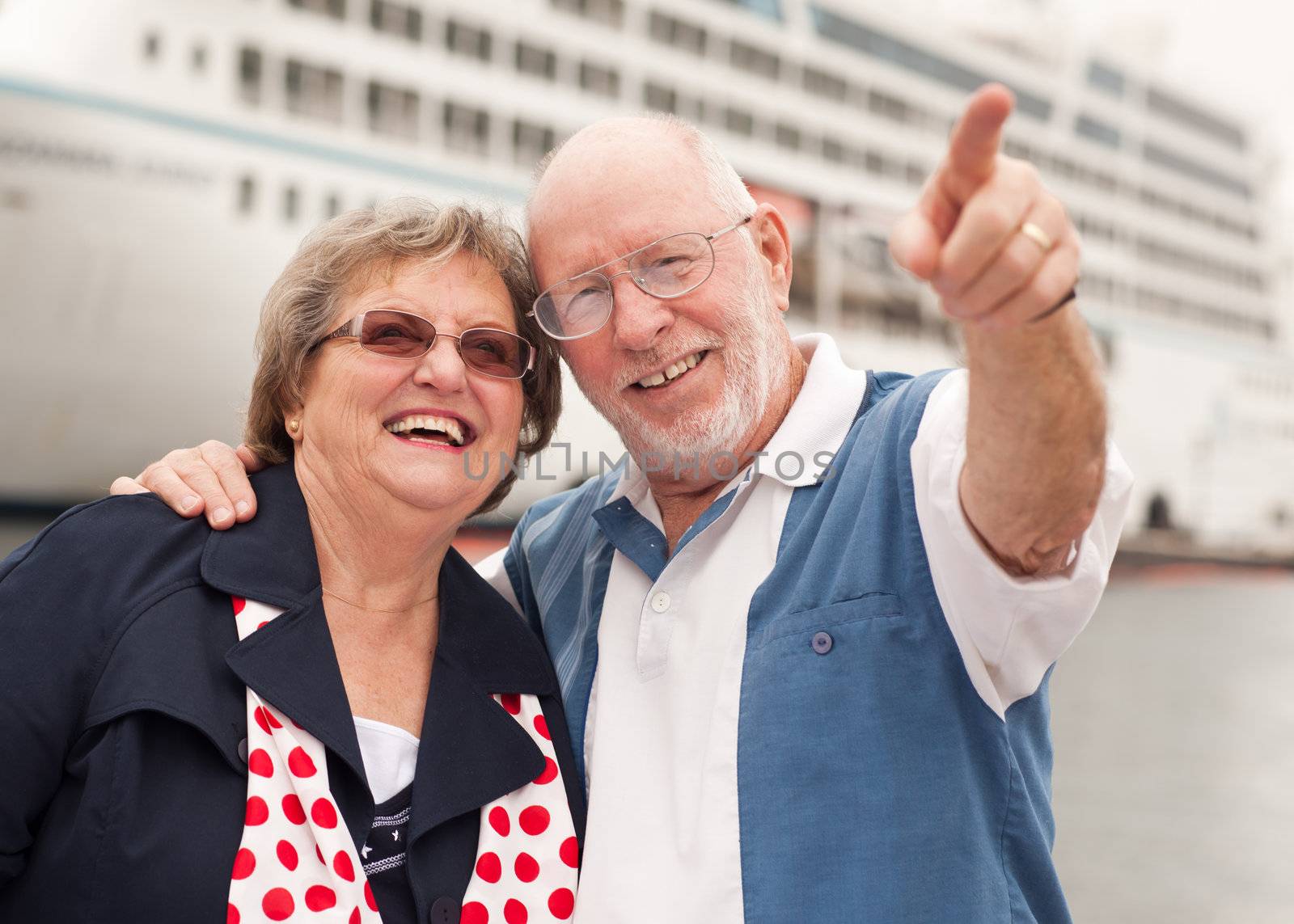 Senior Couple On Shore in Front of Cruise Ship by Feverpitched