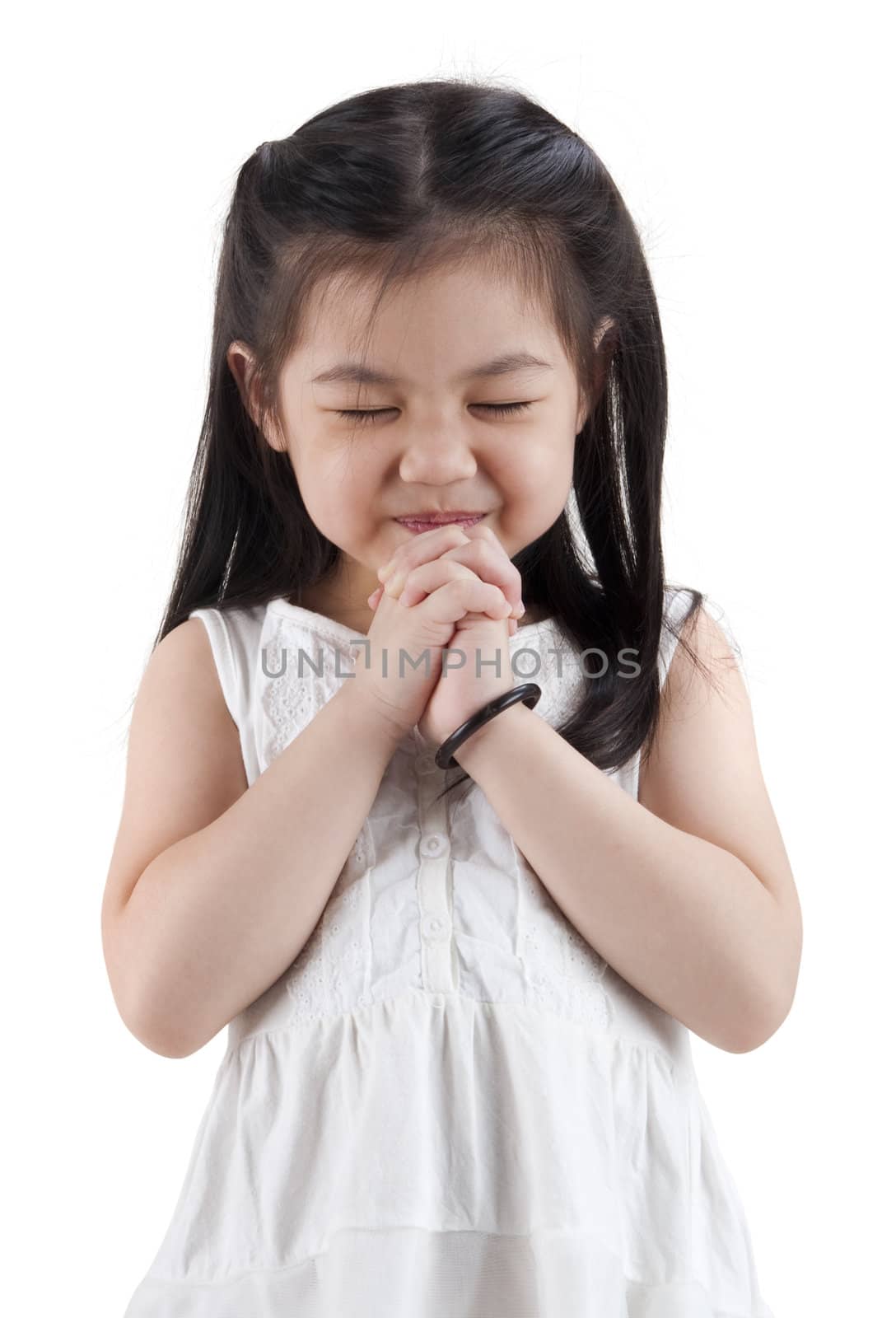 Little girl wishing on white background