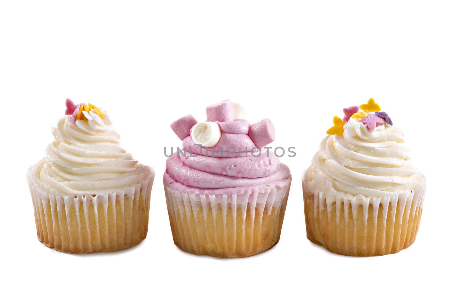 Pink and cream cupcakes against a white background with space for text by tish1