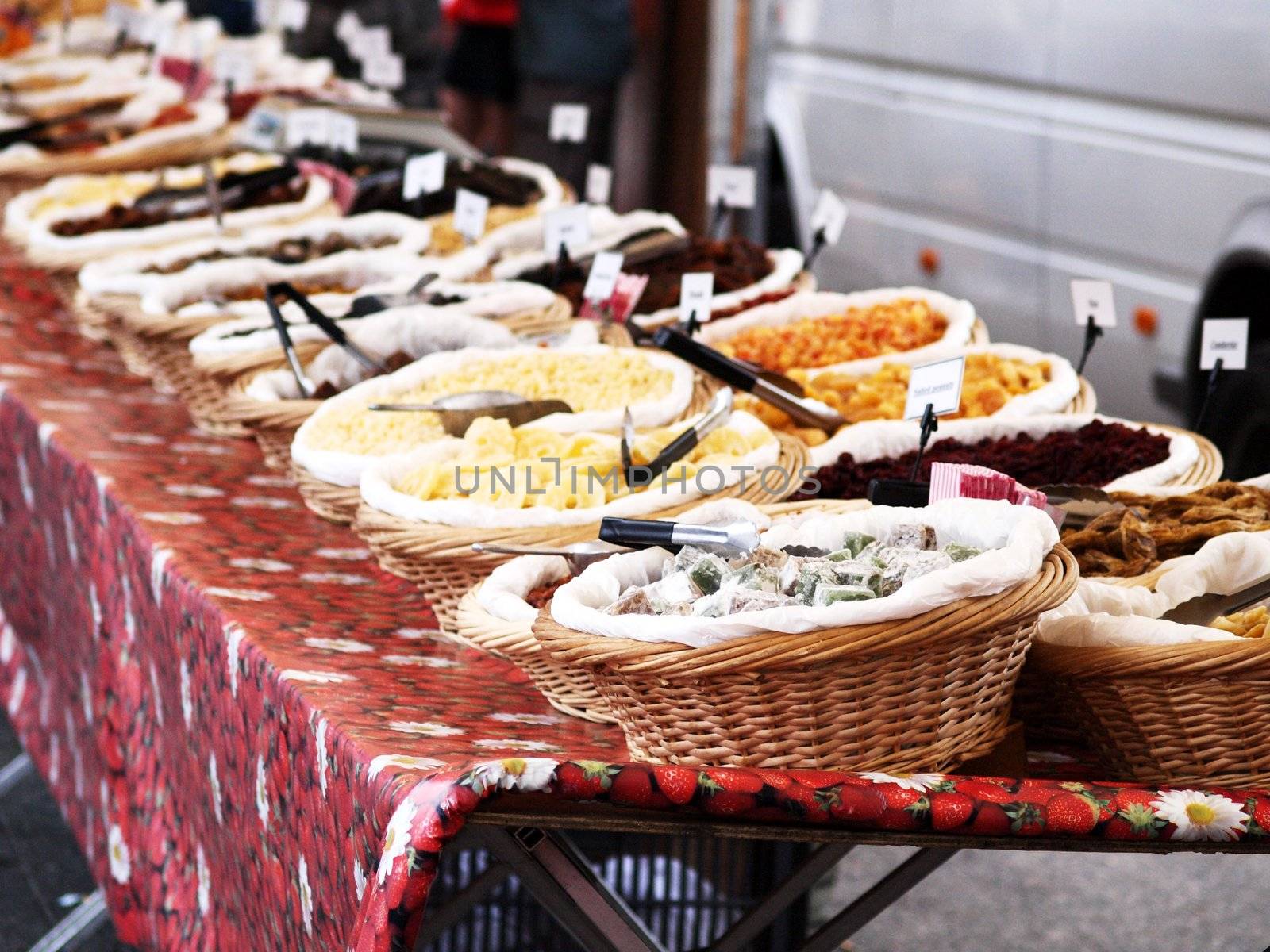 Fresh and dry fruit placed in baskets, onto a table outdoors