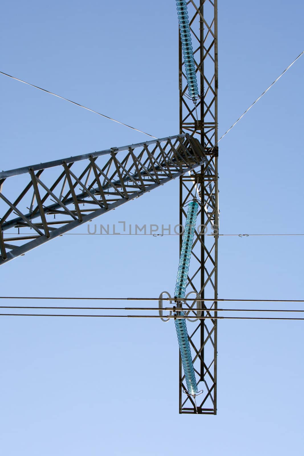 High voltage electricity pylon structures against blue sky