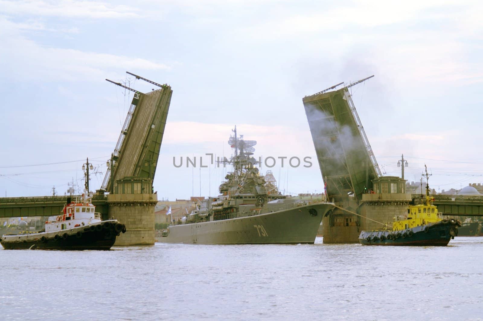 A naval craft tugged through raised Schmidt's drawbridge over Neva river in Saint Petersburg, Russia.