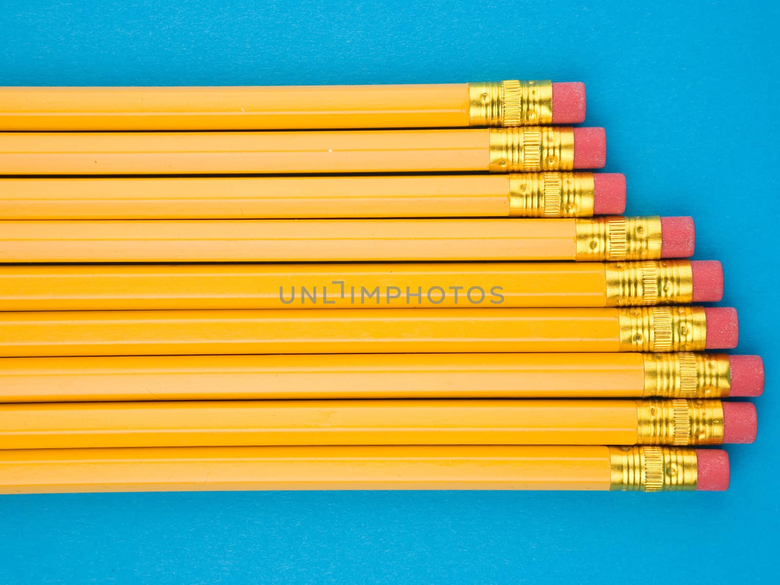 Yellow pencils on blue background