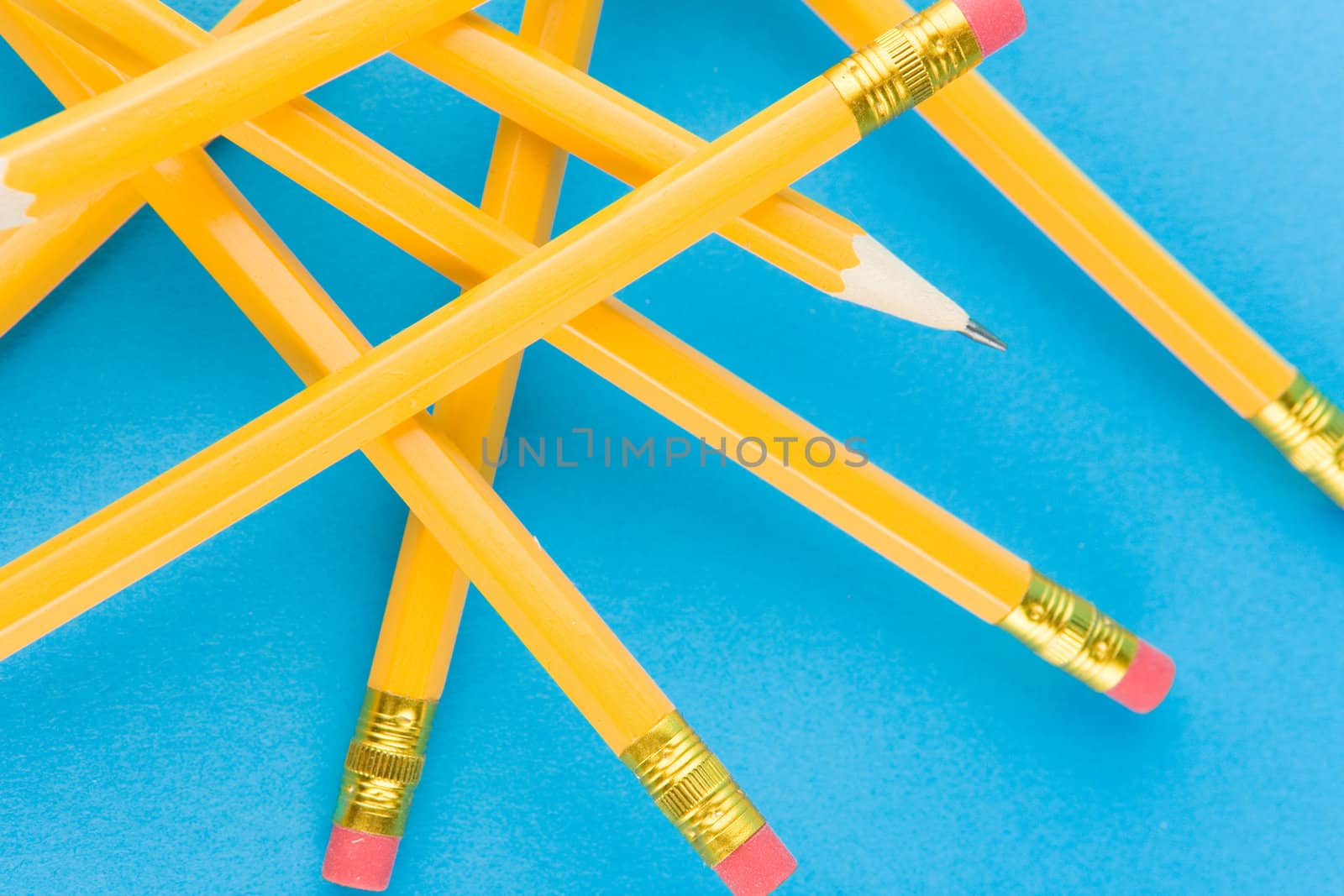 Yellow pencils on blue background