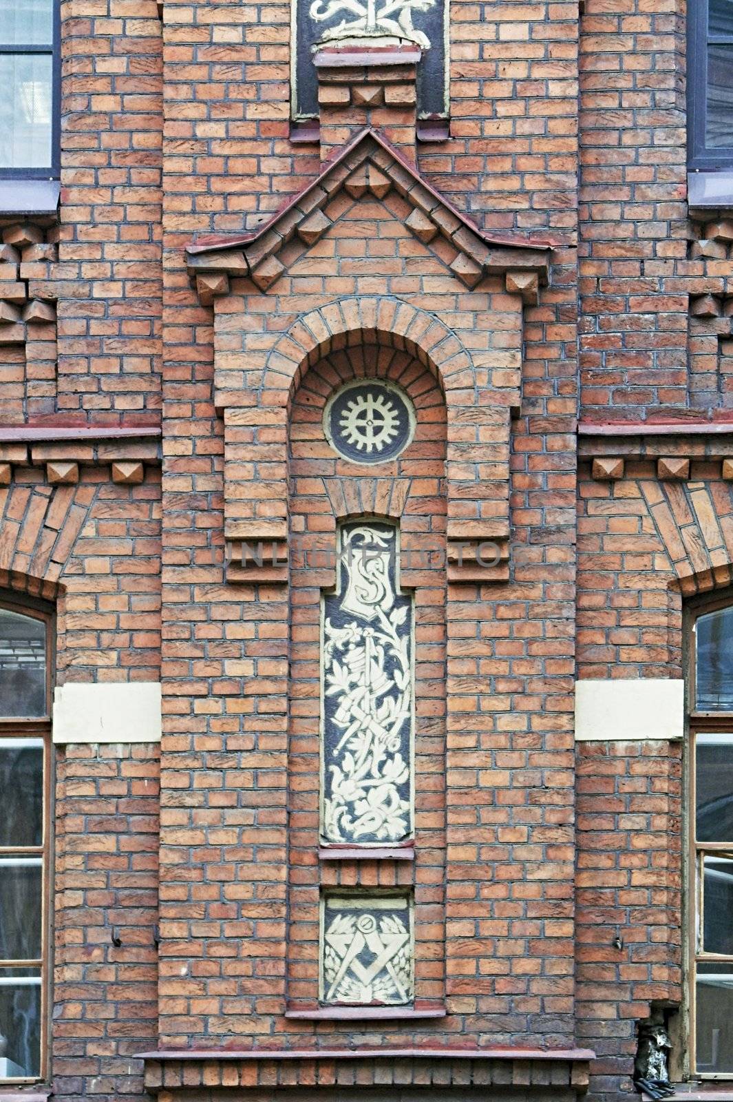 Ornamented Brick Facade of Old Building by simfan
