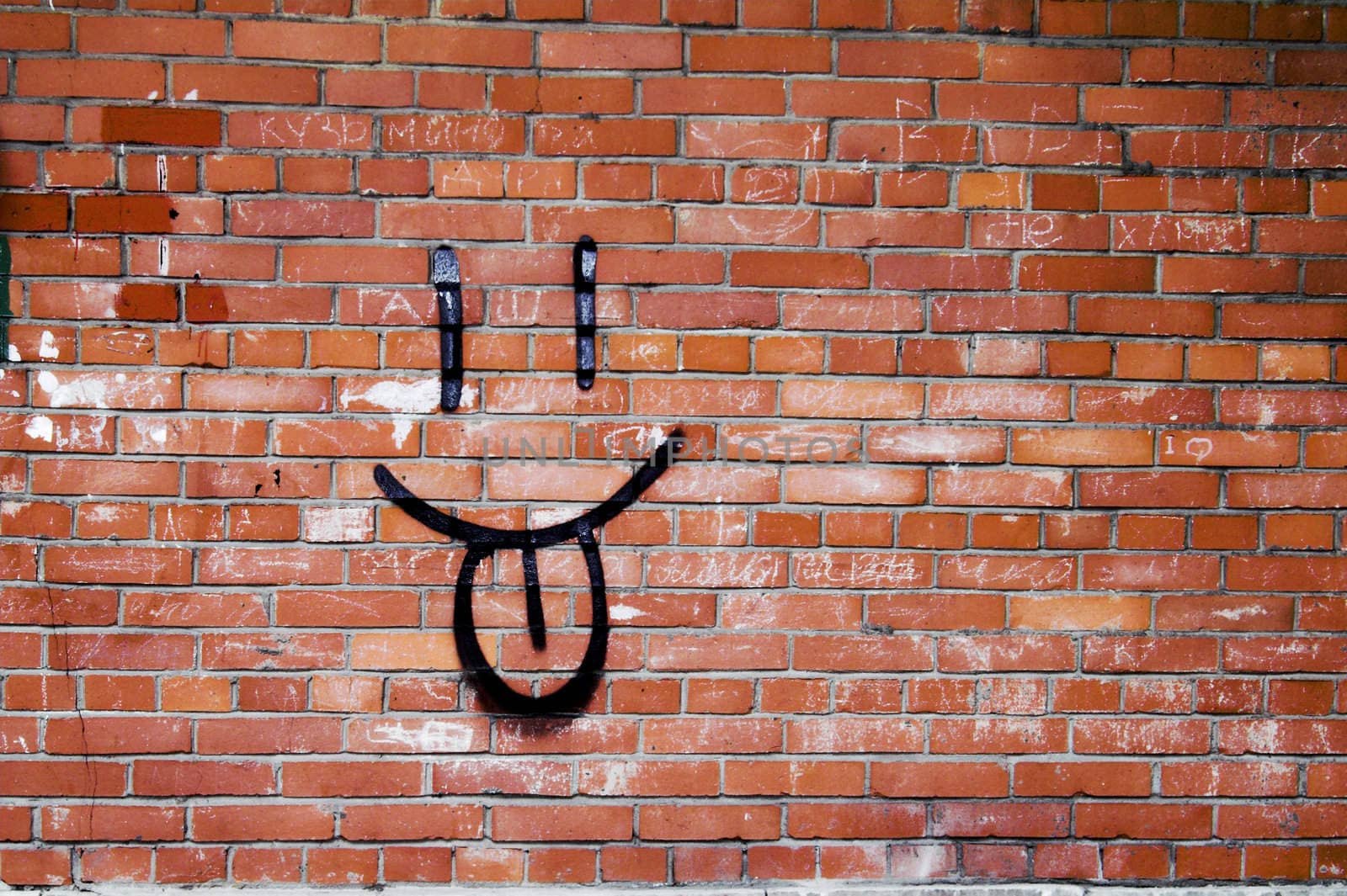 Smile Graffiti on a Red Brick Wall.
