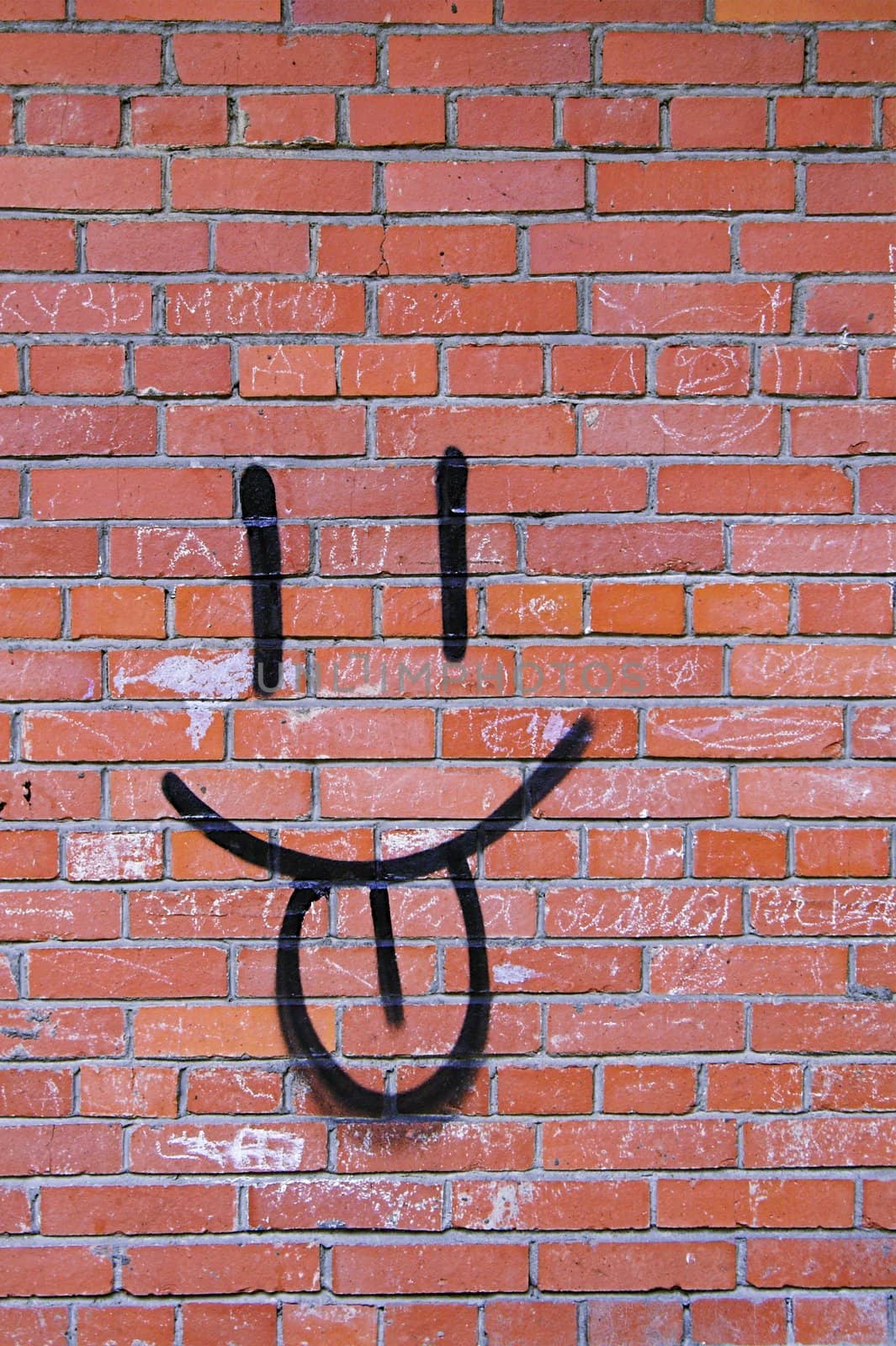 Smile Graffiti on a Red Brick Wall.